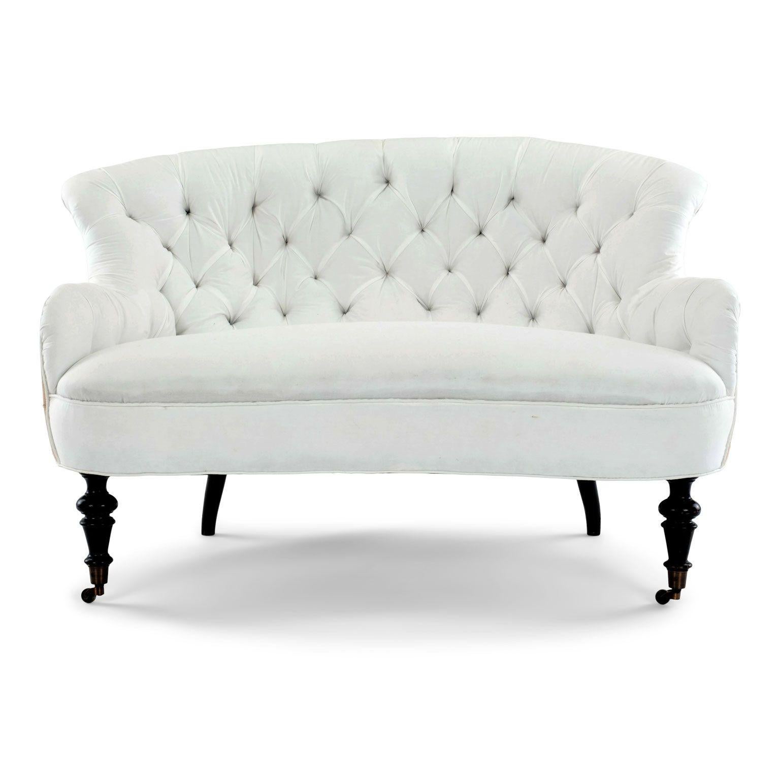 Napoleon III French settee upholstered in off-white ticking and burlap. Ready to be re-covered in your own fabric. Constructed circa 1870-1889 with wood and iron frame, turned and ebonized front legs on brass casters and hand-carved and ebonized