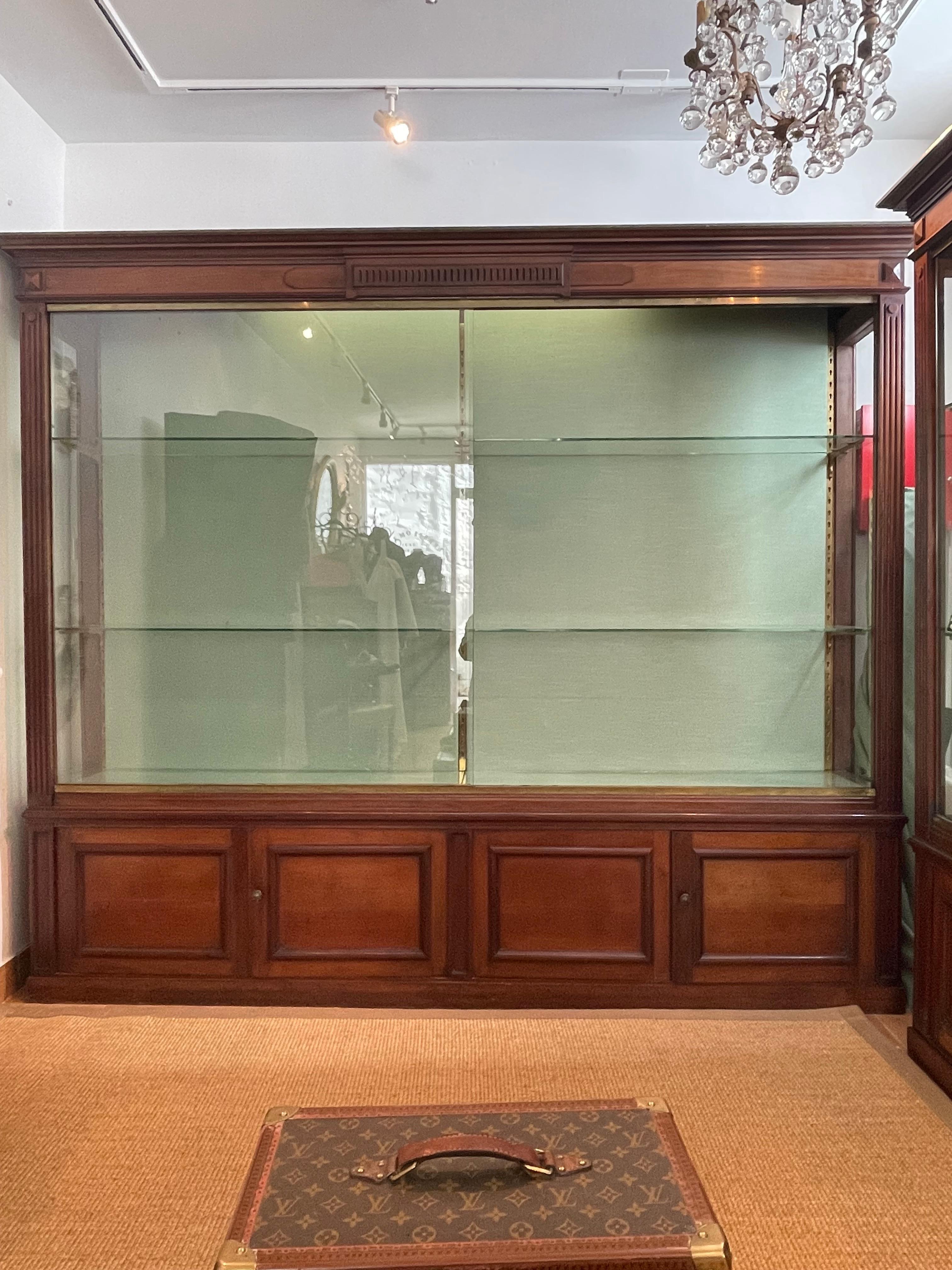 Large mahogany shop window in Louis XVI style, Napoleon III period, six glass and bronze equary shelves. Two sliding glass panels for opening, four closet doors underneath. Showcase very functional because a lot of storage, very easy to assemble and