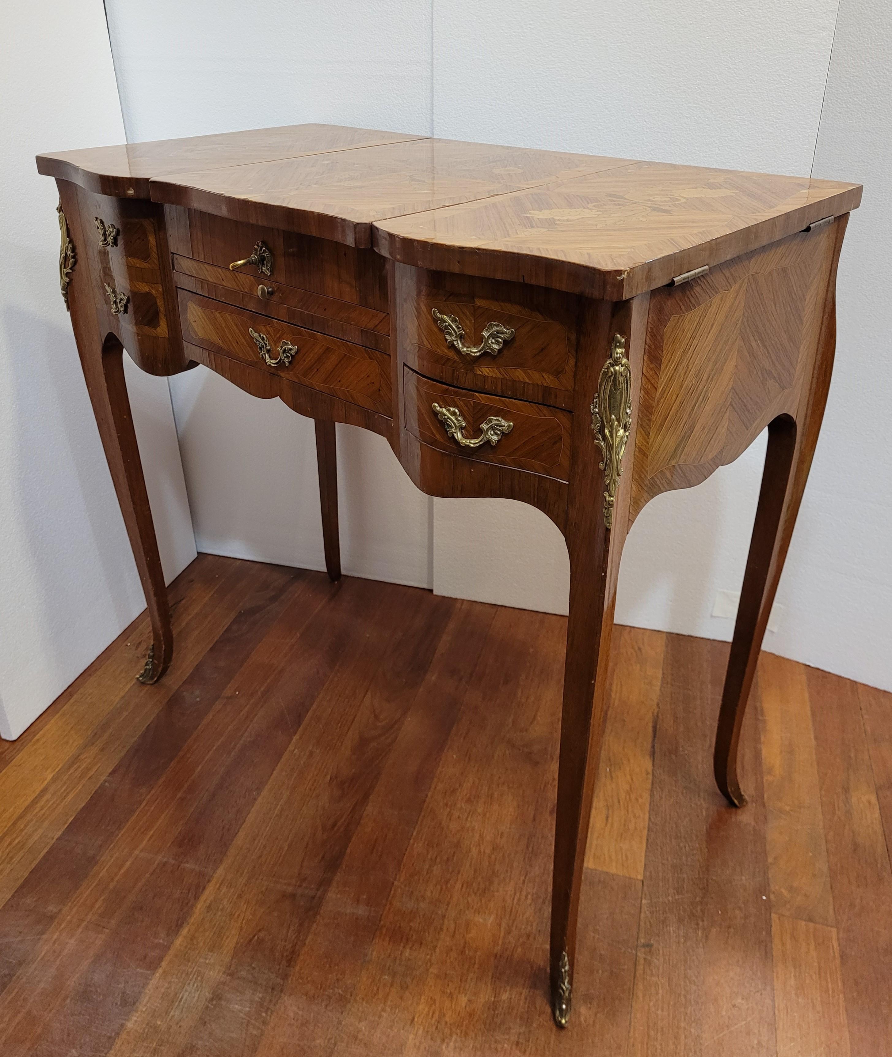 Amazing and refined Louis XV   poudreuse or dressing table made in Napoleon III-era France, mid-19th century. It presents extraordinary marquetry of good invoice; different woods are used for the ornaments, both polygonal and floral. This light