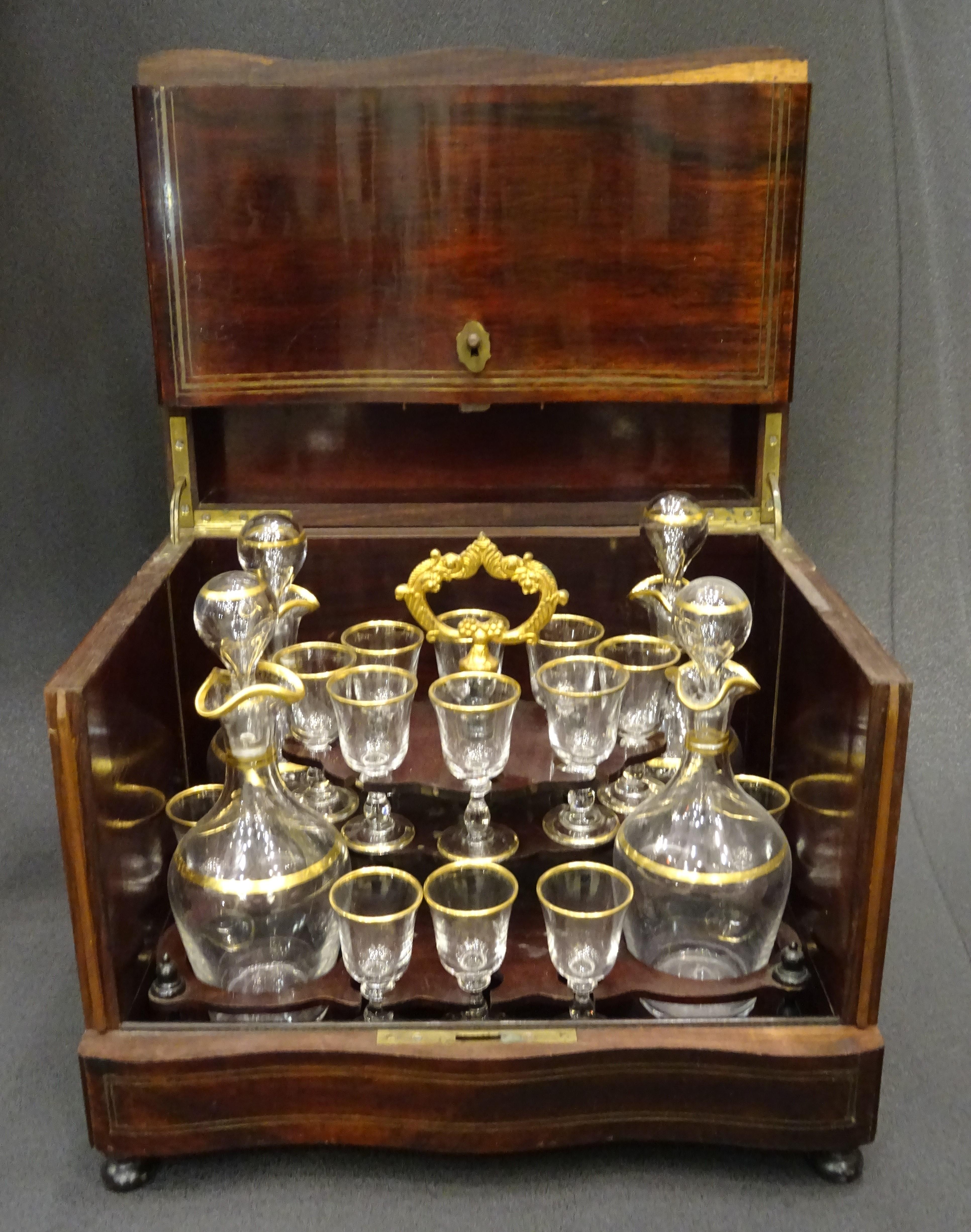 Stunning and one of a kind French travel decanter, Napoleon III, circa 1860, 19th century. Wooden box with inlaid brass that opens front and side doors. Inside there are 24 decanters and 16 glasses for liquor in exquisite blown cut crystal with gold