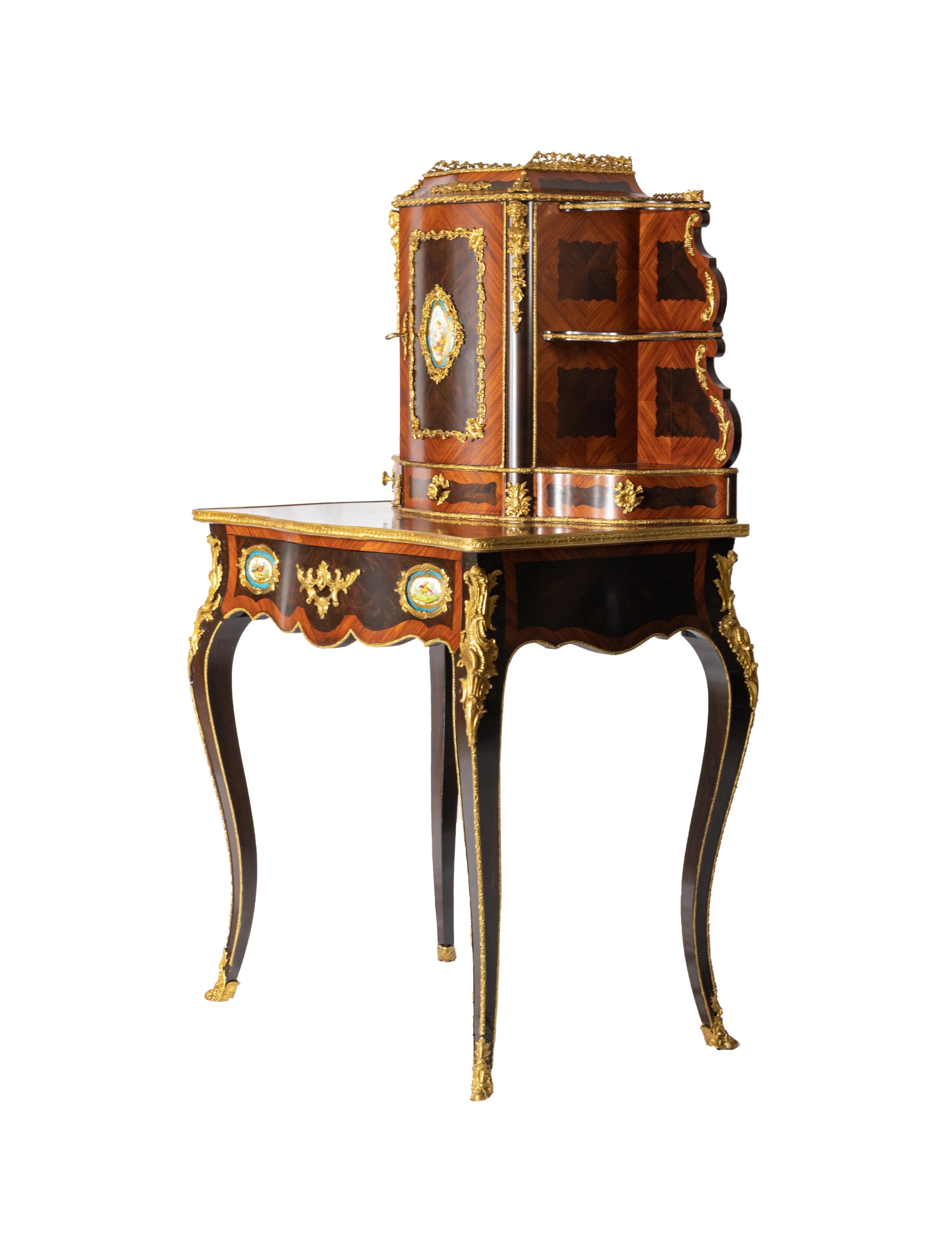 Napoléon III Gilt-Bronze and Sèvres Style Ormolu mounted Bonheur du
Jour by Louis Grade.
This beautiful Bonheur du Jour is a superb example of the taste, artistic sensibilities and
craftsmanship that prevailed during the reign of Napoleon III. 
The