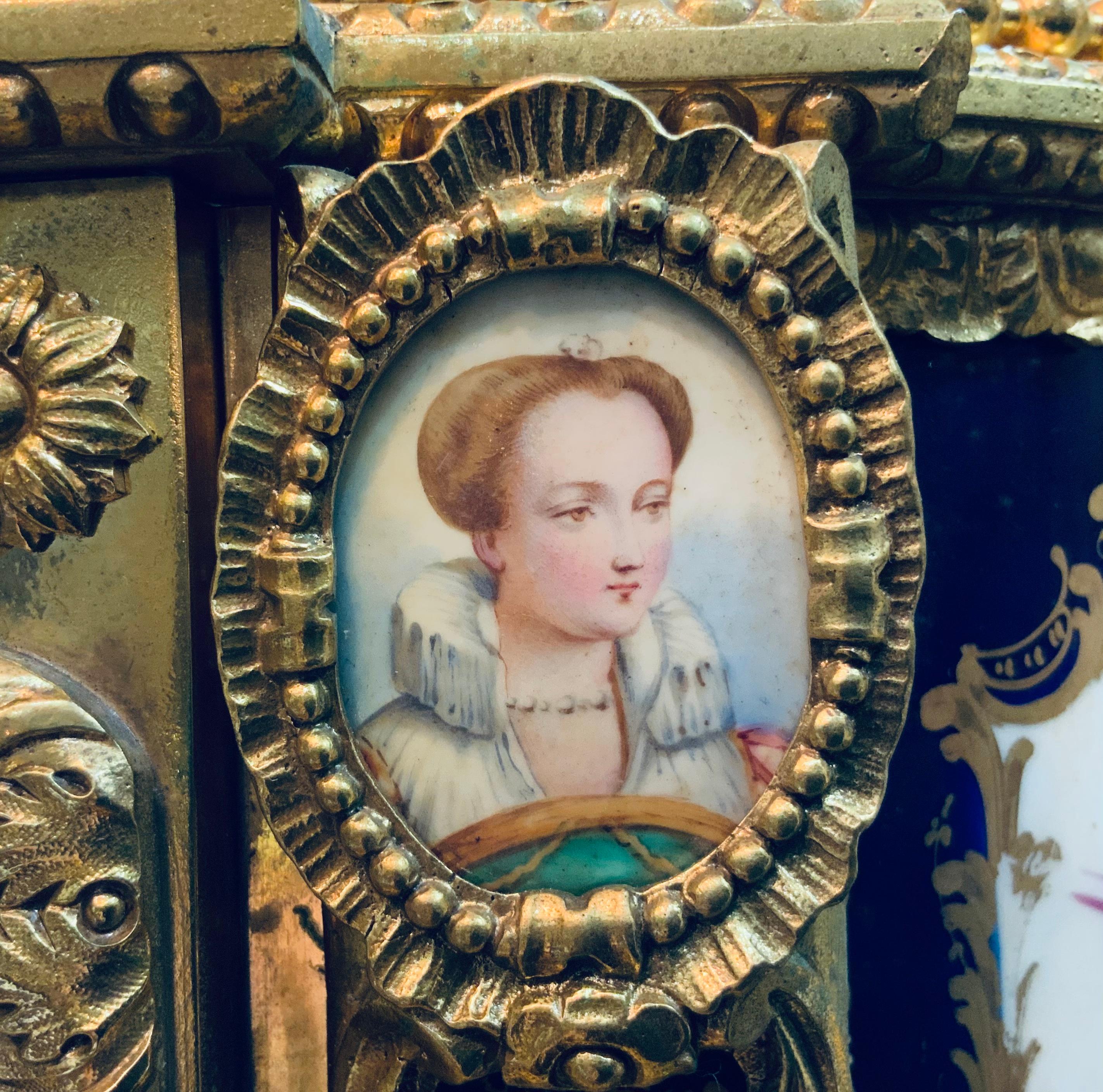 This is a Napoleon lll gilt bronze mounted Sevres style porcelain mantel clock/ garniture. It depicts a porcelain with a cobalt blue background hand painted of cartouches with different scenes of pair of cherubs, courting couples, a maid in a garden