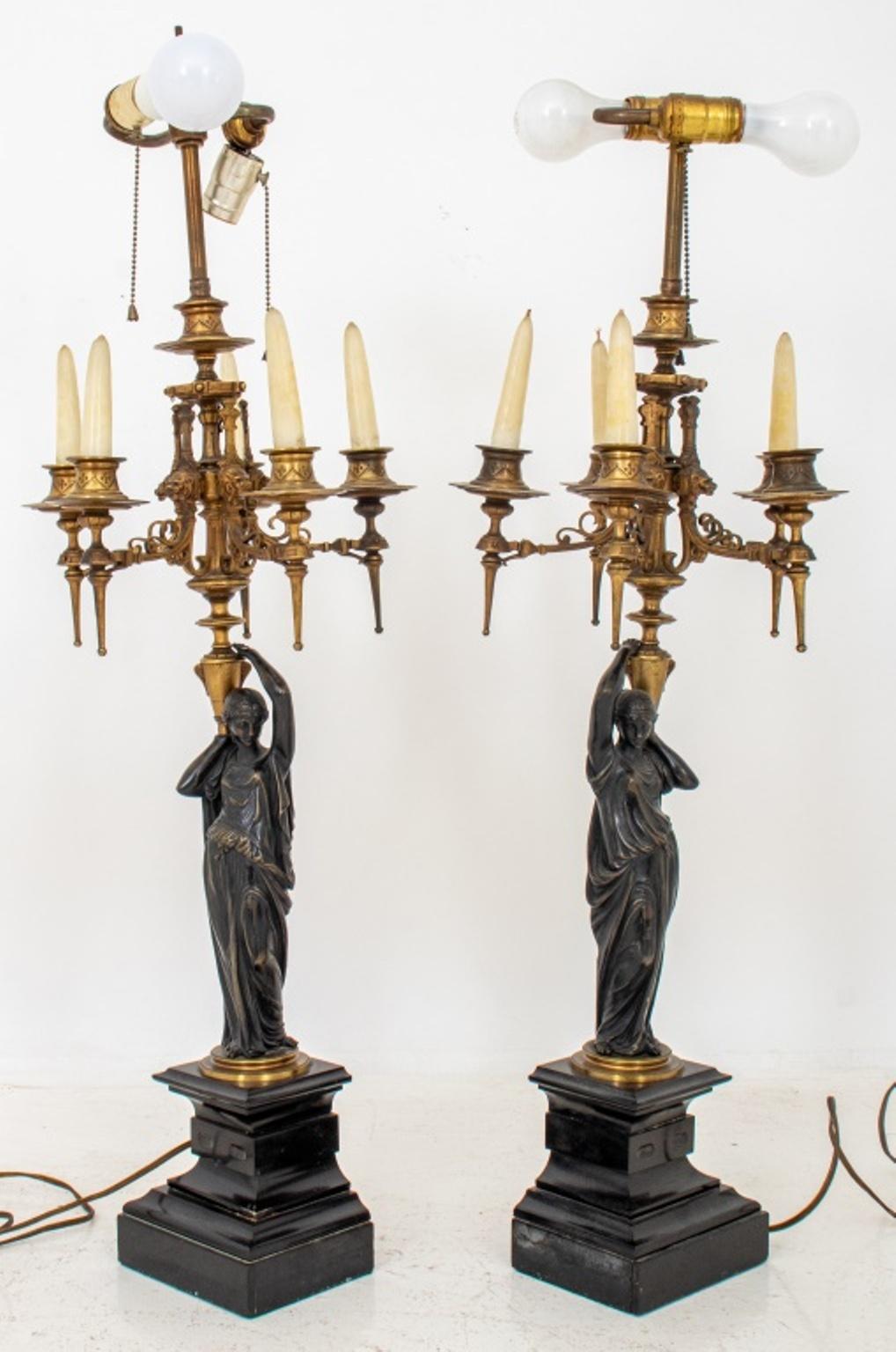 Napoleon III Neoclassical Gout Grec gilded and patinated bronze six-arm candelabra in the form of draped Roman vestals supporting amphorae in the manner of Hippolyte Ferrat (French, 1822 - 1882) issuing candle arms above black noir de Belge