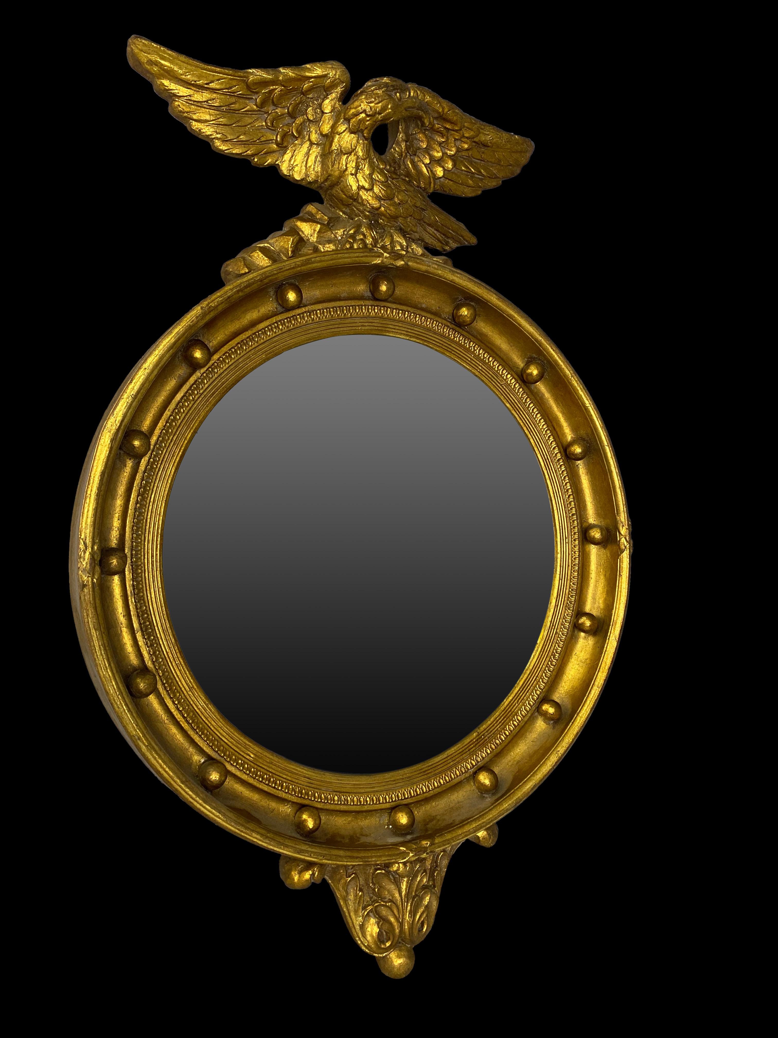 19th century oval mirror of Napoleon III period. Carved wood, covered with gold leaf finish. This piece has beautiful ornaments and an eagle on the top, wearing vintage glass, France, 1800s.

Dimensions (cm):
70 H, 50 W, 13 D.
