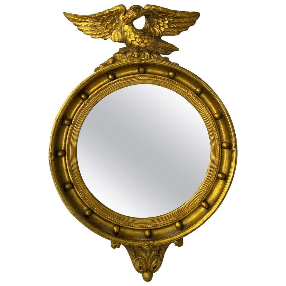 19th century oval mirror of Napoleon III period. Carved wood, covered with gold leaf finish. This piece has beautiful ornaments and an eagle on the top, wearing vintage glass, France, 1800s.