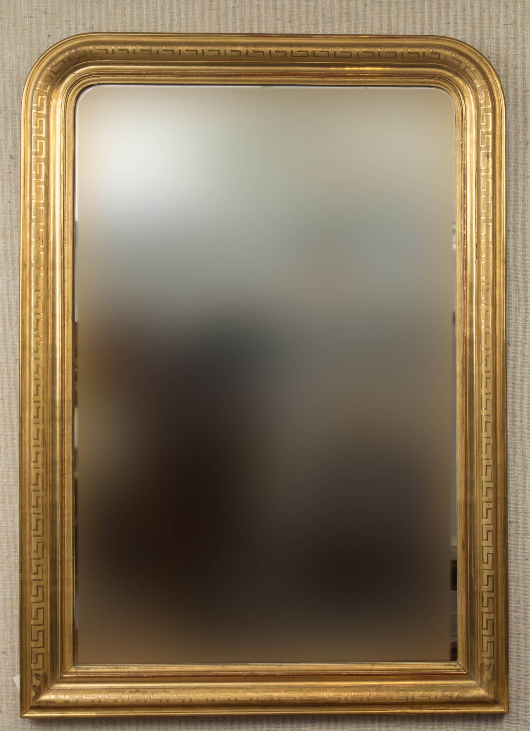 19th century giltwood mirror with Greek key motif encompassing entire frame. Original glass.