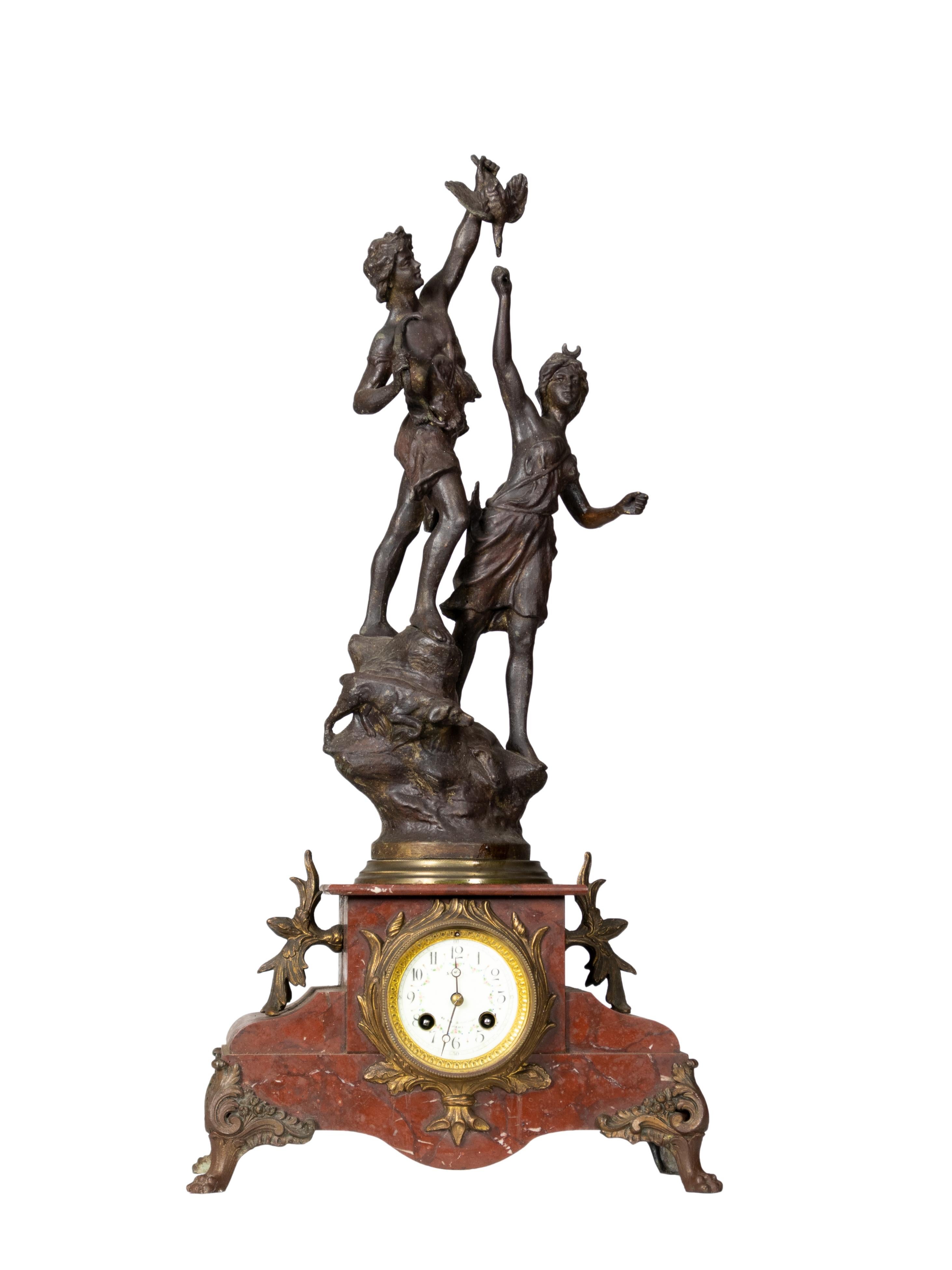 A complete and in working order metal mantel clock with an esteemed figure of the Roman Goddess Diana the Huntress with a nymph by her side, with Carrara marble details and a functioning swiss mechanism. 
Recently reviewed by a master clockmaker.

