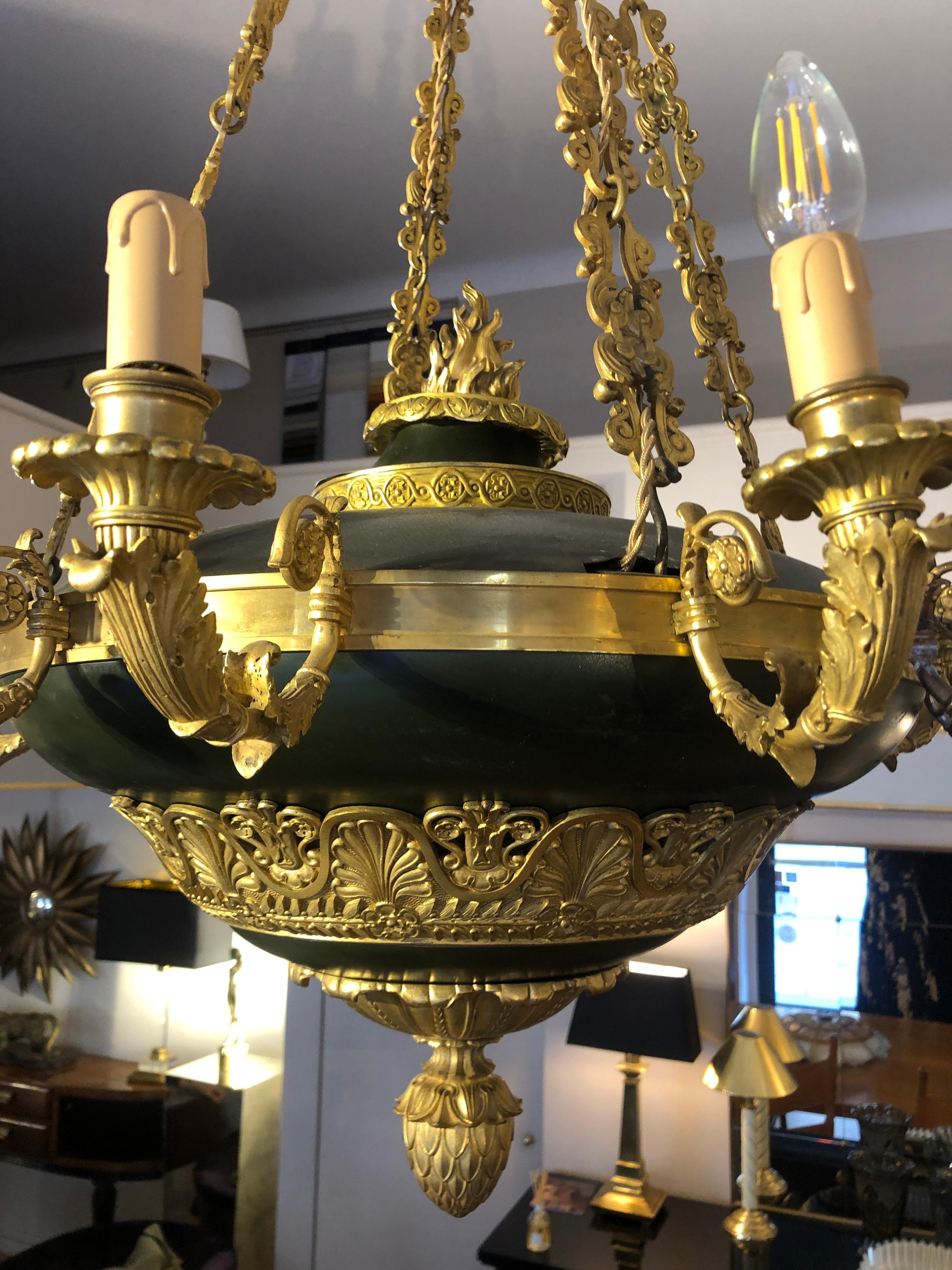 Napoleon III golden bronze and dark green lacquer twelve-light chandelier 

Chandelier from France from Napoleon III late 19th century period. The chandelier features 12-light. The rounded dark green lacquered central body is enriched with golden