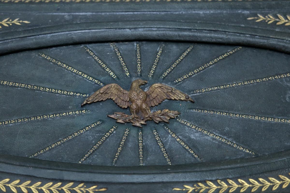 French box from the 19th century made of green leather with gilded embossing and brass ornaments.

Decorated in the center with the imperial eagle of Napoleon III, a symbol of power and victories, above which angels appear.

The box was lined in our