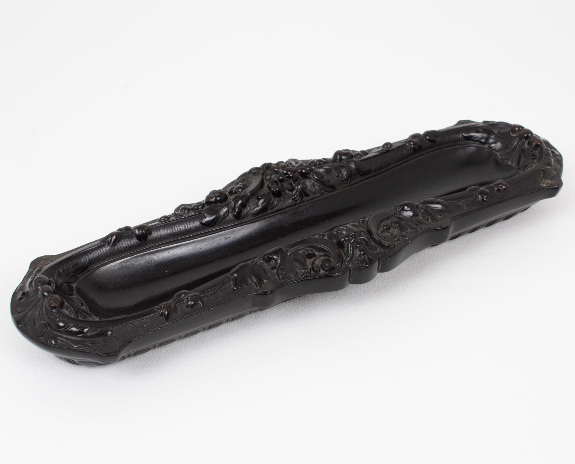 This superb Napoleon III Gutta Percha pen holder was handcrafted in France in the 1880s. The antique desk accessory is exquisitely crafted with different molded designs on each side and delicate ornamentation throughout. There is no known
