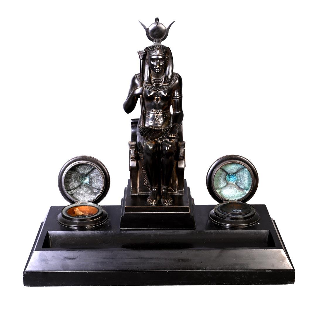 This Egyptian-style inkwell was crafted in France during the reign of Napoleon III.

The centerpiece of the inkwell features a depiction of the goddess Hathor. Front-facing and hieratic, reminiscent of the monumental statues of Ancient Egypt, she is