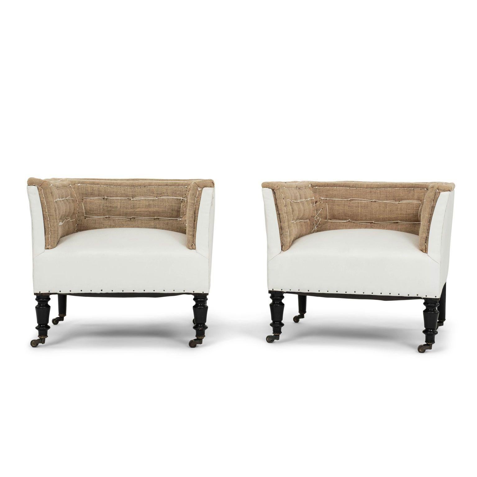 Napoleon III low squared-back chairs on casters circa 1860-1879. Turned and hand-carved ebonized legs on casters. Newly-covered in white ticking and burlap. Sold together and priced $6,800 for the pair.

Note: Original/early finish on antique and
