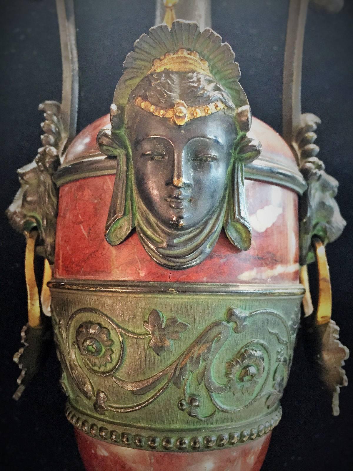 A garniture is a decoration for the top of a fireplace mantel. Presented here is a good example of richly patinated and gilded bronze and red marble in the style of Napoleon III, whose reign period was during the time of the Second French Empire,