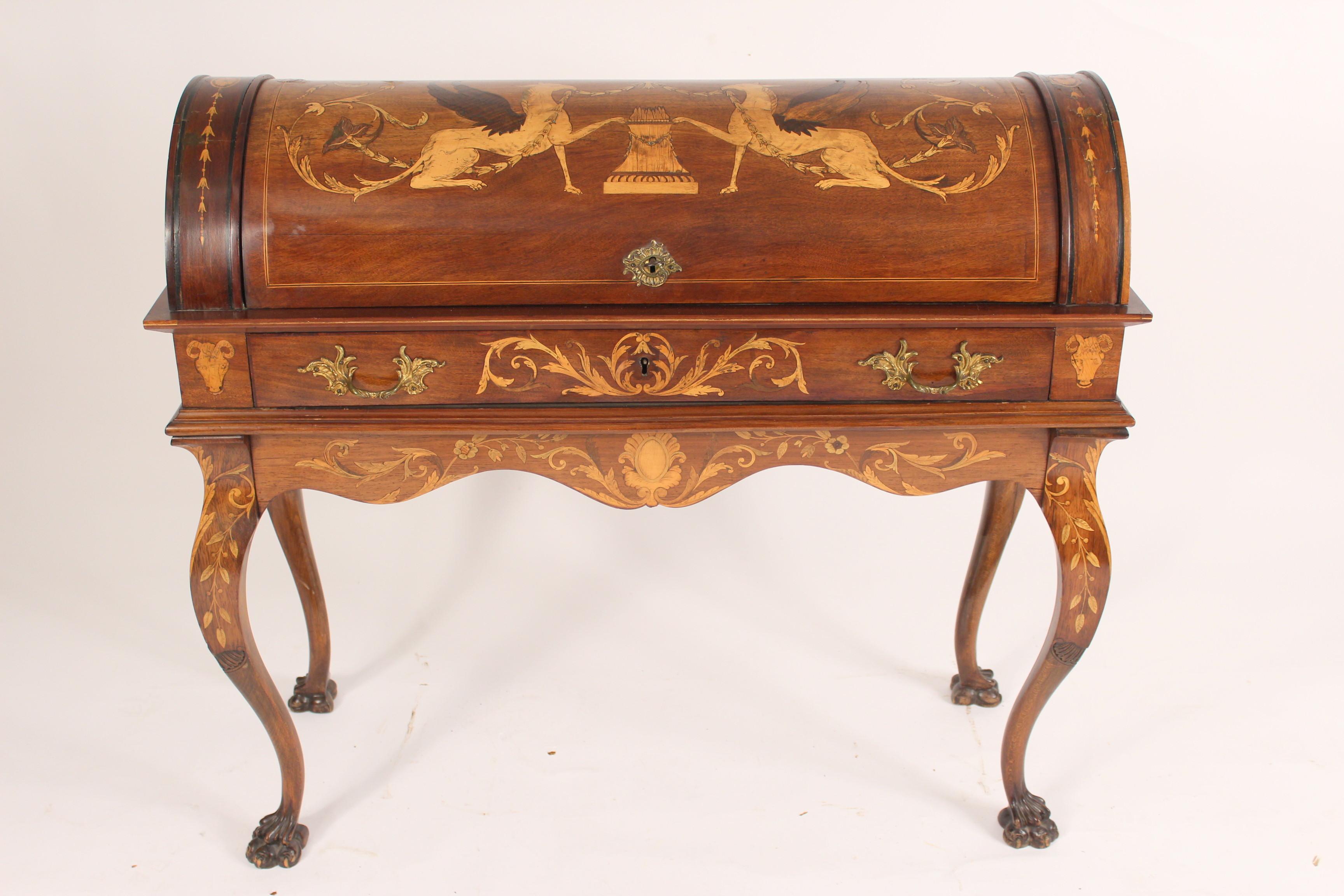 Unusual Napoleon III marquetry inlaid cylinder desk, circa late 19th century. The cylinder top is inlaid with griffins, bell flowers and scrolling vines. With a tooled leather writing surface. The cabriole legs end in paw feet. Fine quality brass