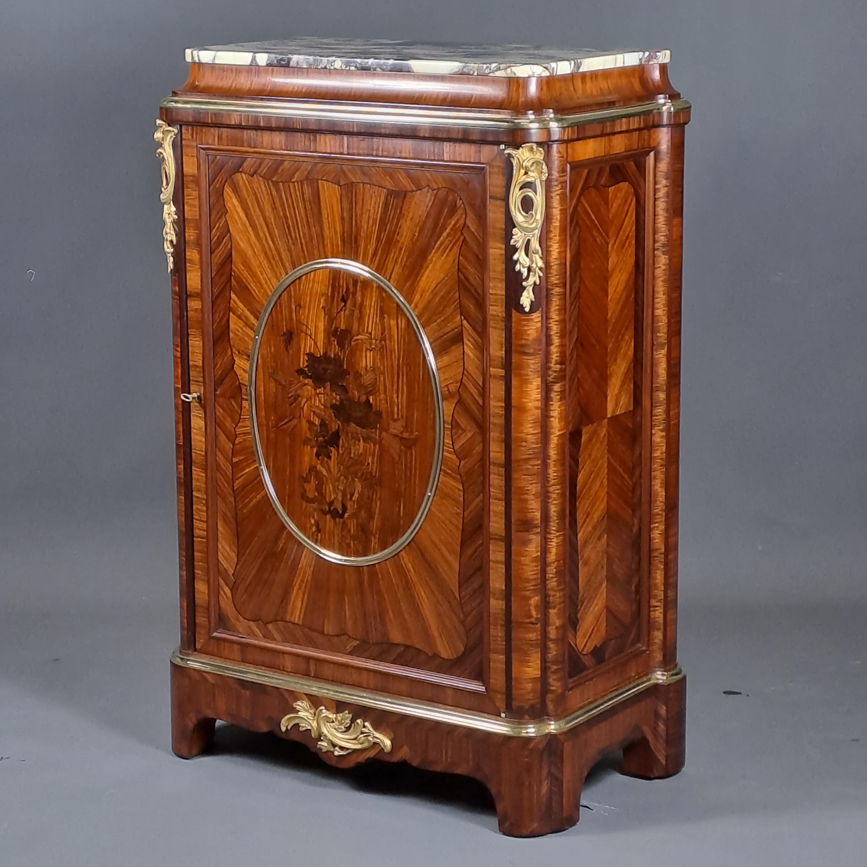  Elegant Napoleon III Meuble D'Appui in Rosewood marquetry opening a door with a medallion with a floral motif.
Oval top capped by a black veined white marble top. Rich ornamentation of finely chiseled gilt bronze.

Furniture attributed to Gervais