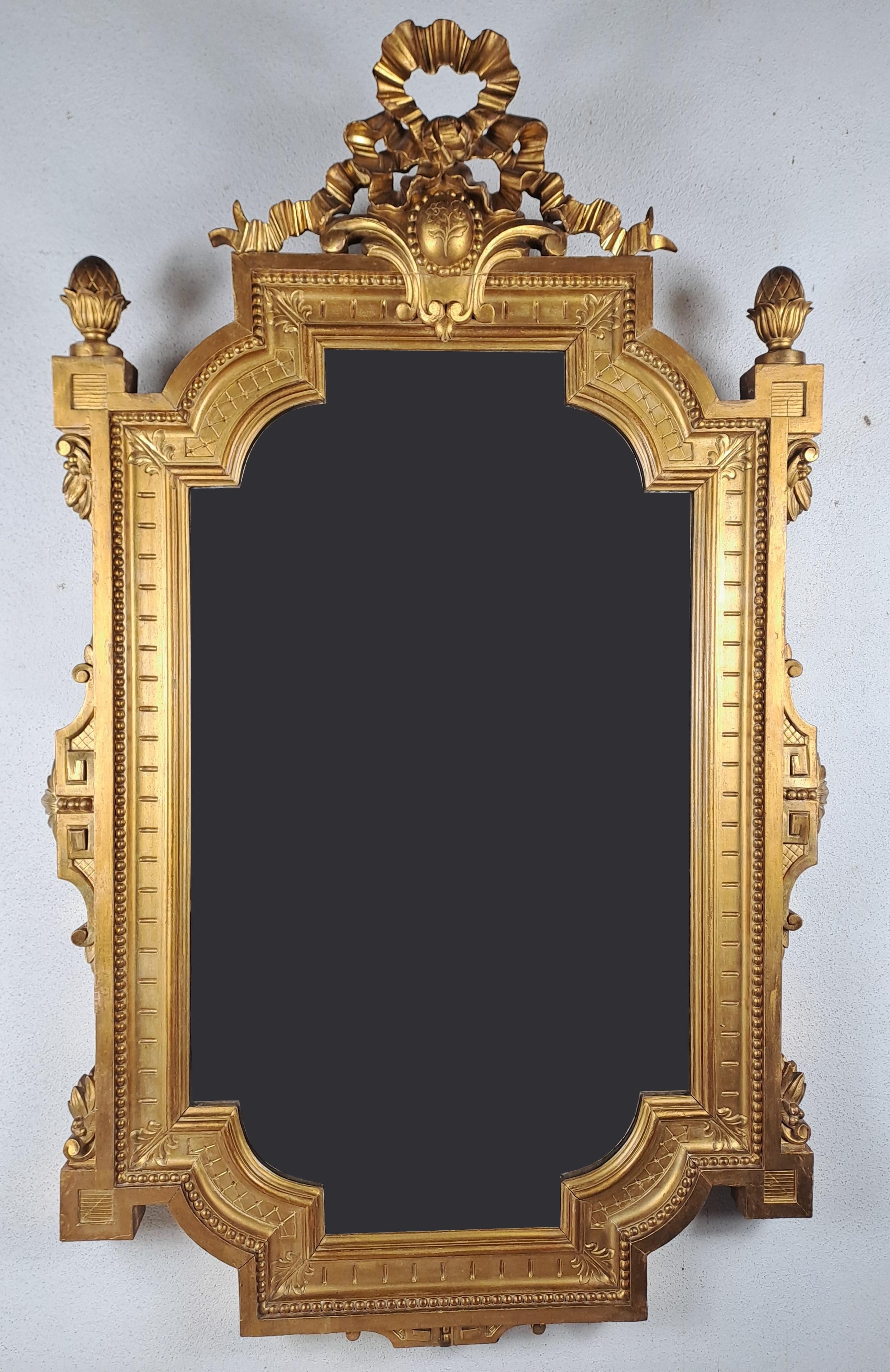 Superb mirror from the Napoleon III period with geometric and symmetrical shapes in the spirit of the Renaissance and with a fronton composed of a medallion and a tied ribbon.
Rare model.

French work around 1850.

Mercury glass slightly pitted