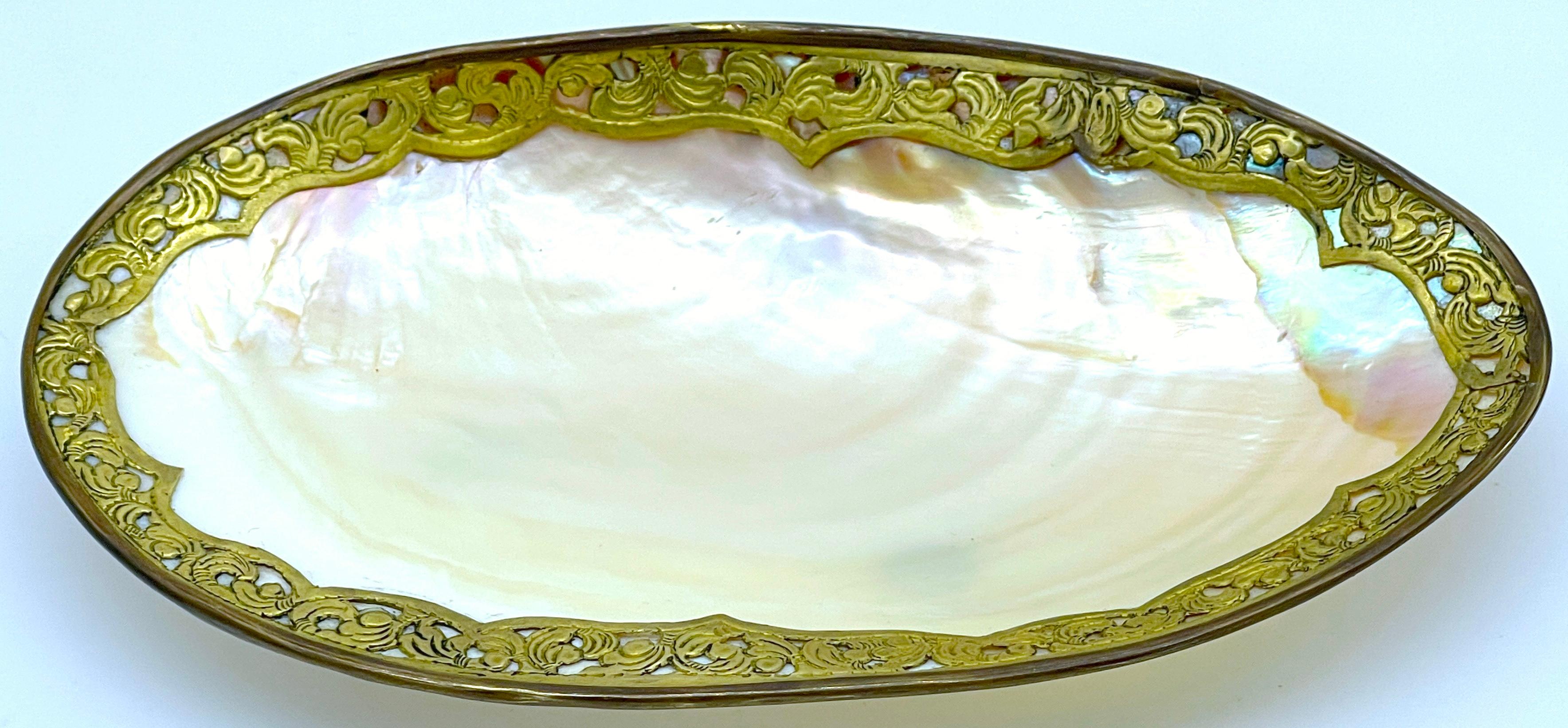 Napoleon III Ormolu Mounted Footed Shell Dish/Vide-Poche
France, circa 1870s

An exquisite Napoleon III Ormolu Mounted Footed Shell Dish/Vide-Poche from France, circa the 1870s. This captivating piece features an oval naturalistic form, measuring 10