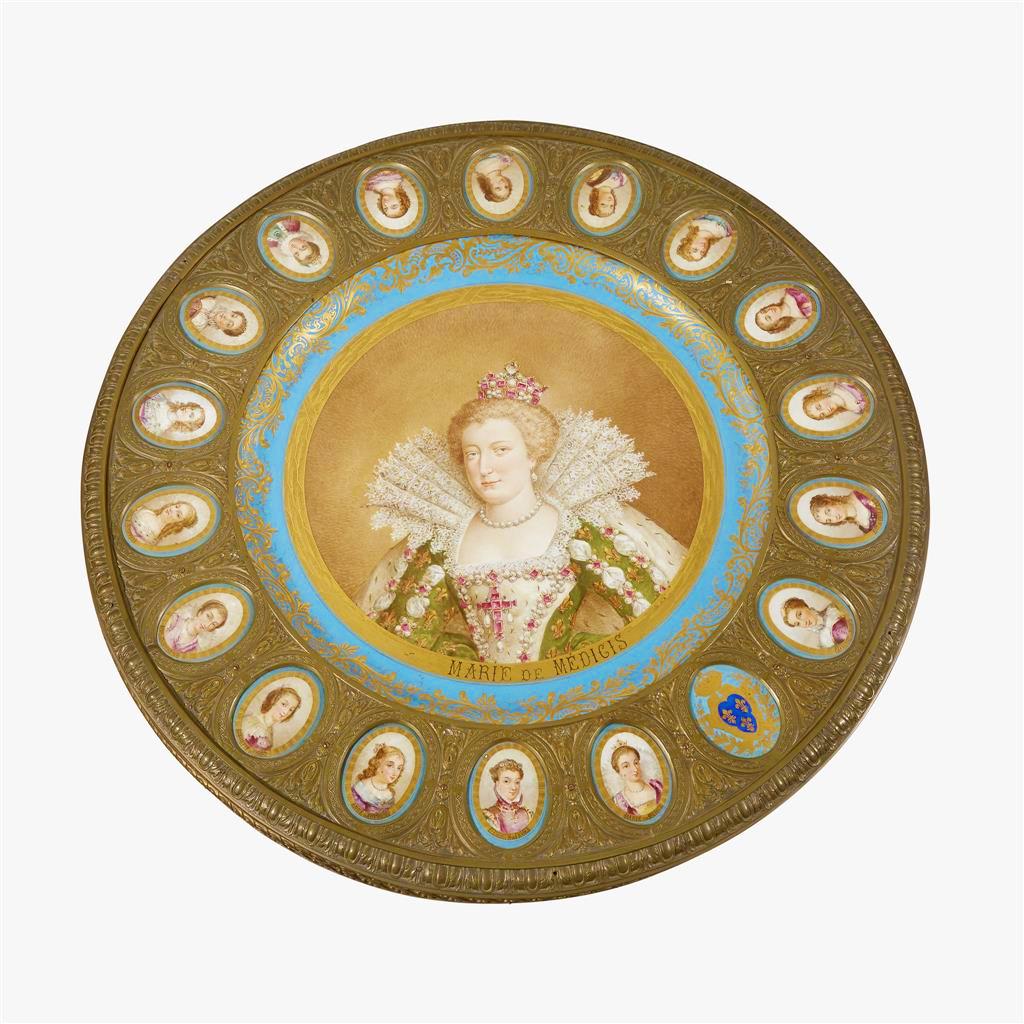 An important Napoleon III Sèvres-style gilt bronze mounted onyx center table with porcelain plaques. The circular bronze mounted top centered by a finely painted and gilt-decorated porcelain portrait of Marie de Médicis encircled by seventeen