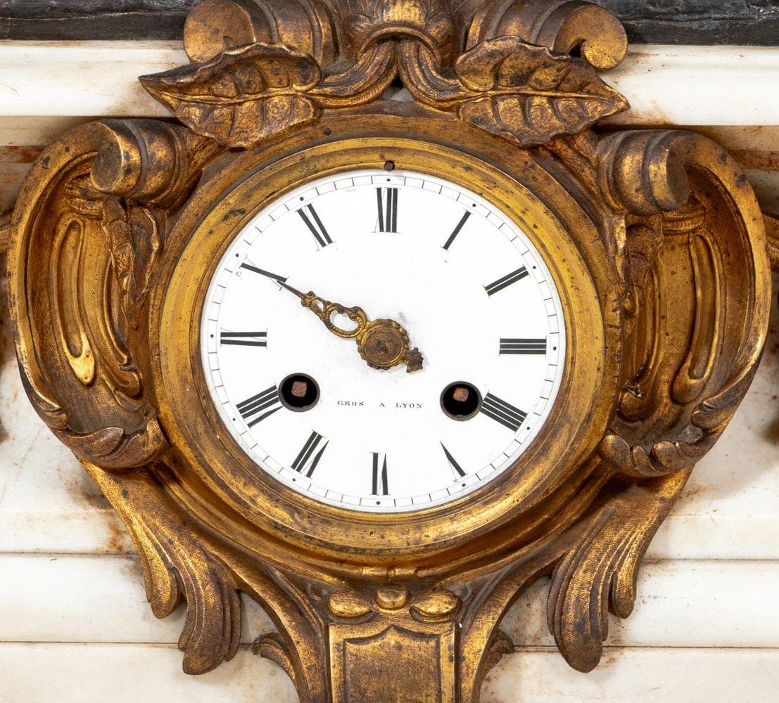 Napoleon III Gilt and Patinated Bronze and White Marble Clock, circa 1870, of rounded rectangular form, the circular white enamel dial signed 
