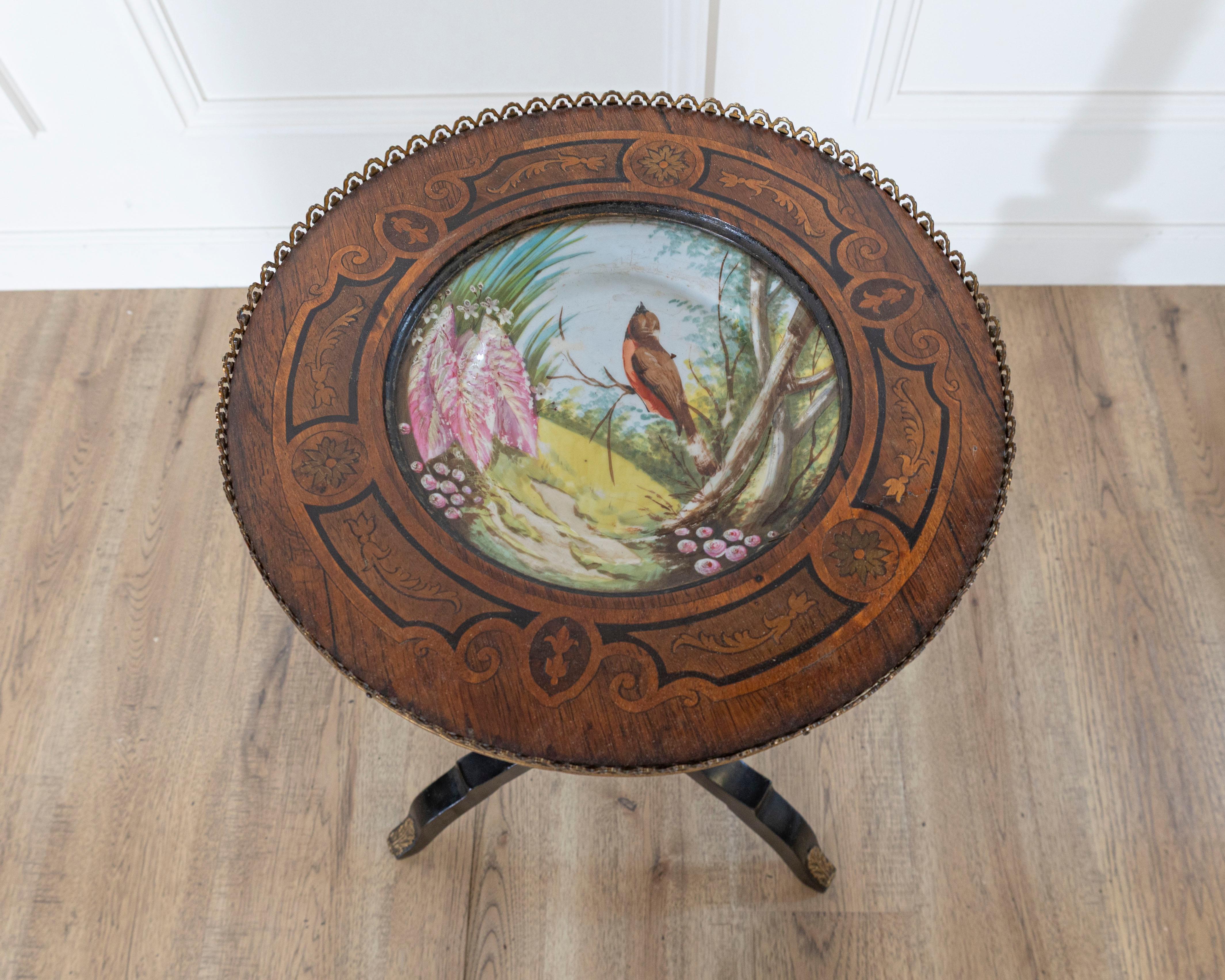 A captivating Napoleon III period pedestal table from 19th-century France, showcasing the elegance and artistry characteristic of the Second Empire. The table features a richly black lacquered finish complemented by finely cast gilt bronze mounts in