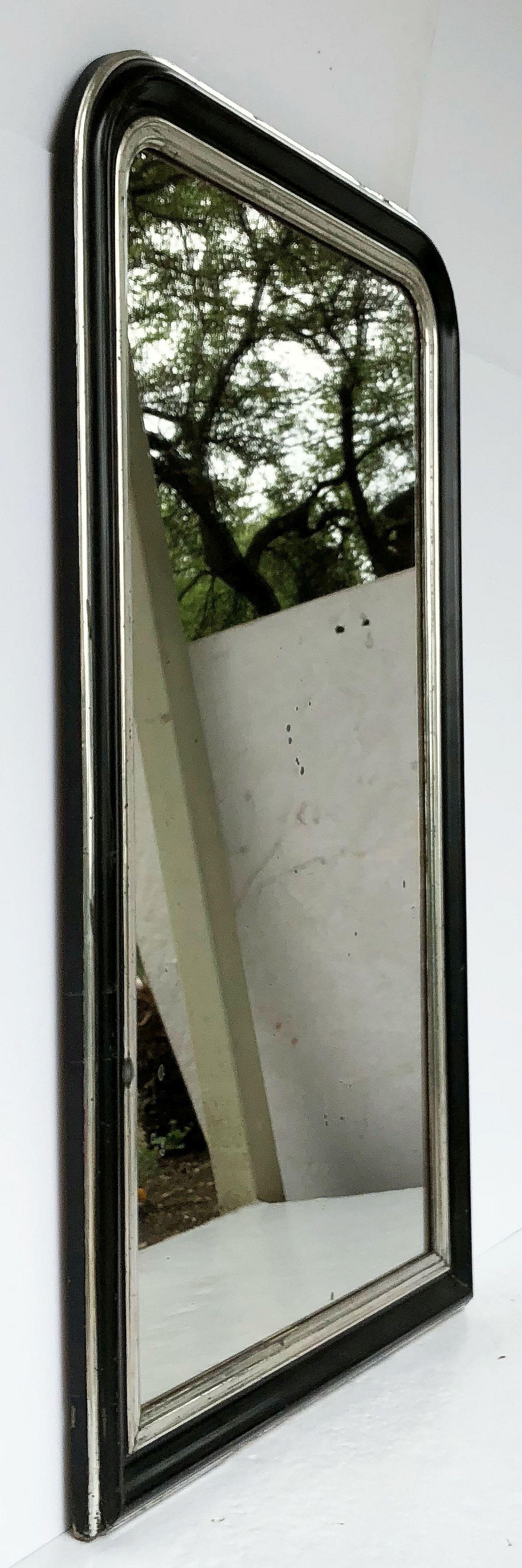 A handsome large Napoleon III period wall mirror featuring a lovely moulded surround and a design around the frame of black and silver leaf, with original mirrored glass.

Dimensions: H 53 1/2 x W 32 1/4