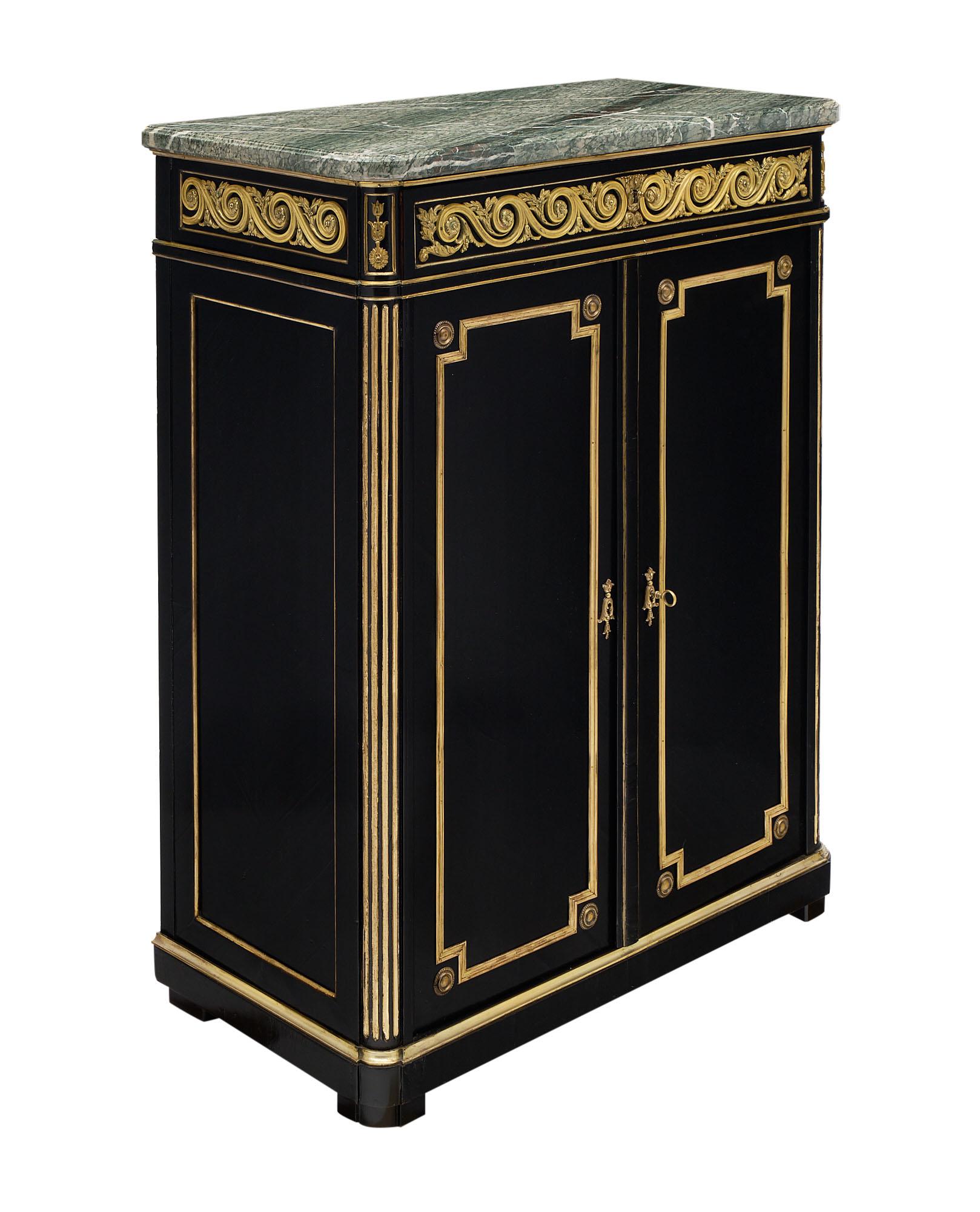 Buffet from France made of ebonized mahogany from the Napoleon III period. The precious cabinet features extensive gilt trims throughout and a rich ormolu frieze adorning the apron. The Pietra Verde marble top is intact and original.