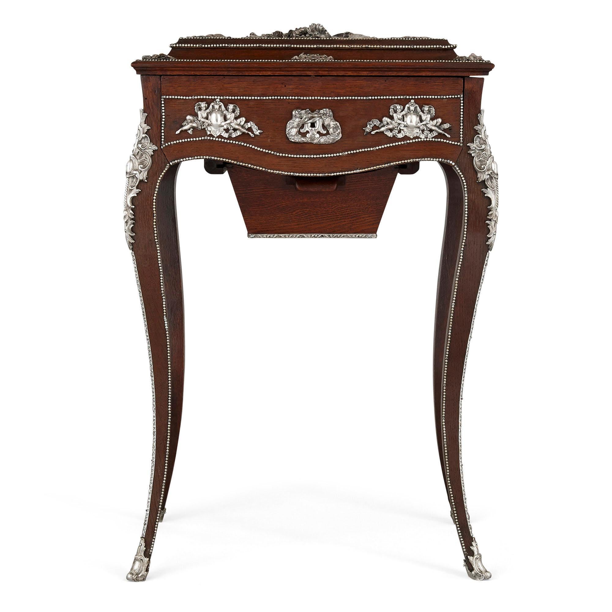 Napoleon III period dressing table, attributed to Diehl
French, circa 1870
Measures: Height 78cm, width 50cm, depth 38cm

This magnificent dressing table is crafted from dark wood mounted with silvered bronze. The table is raised on four