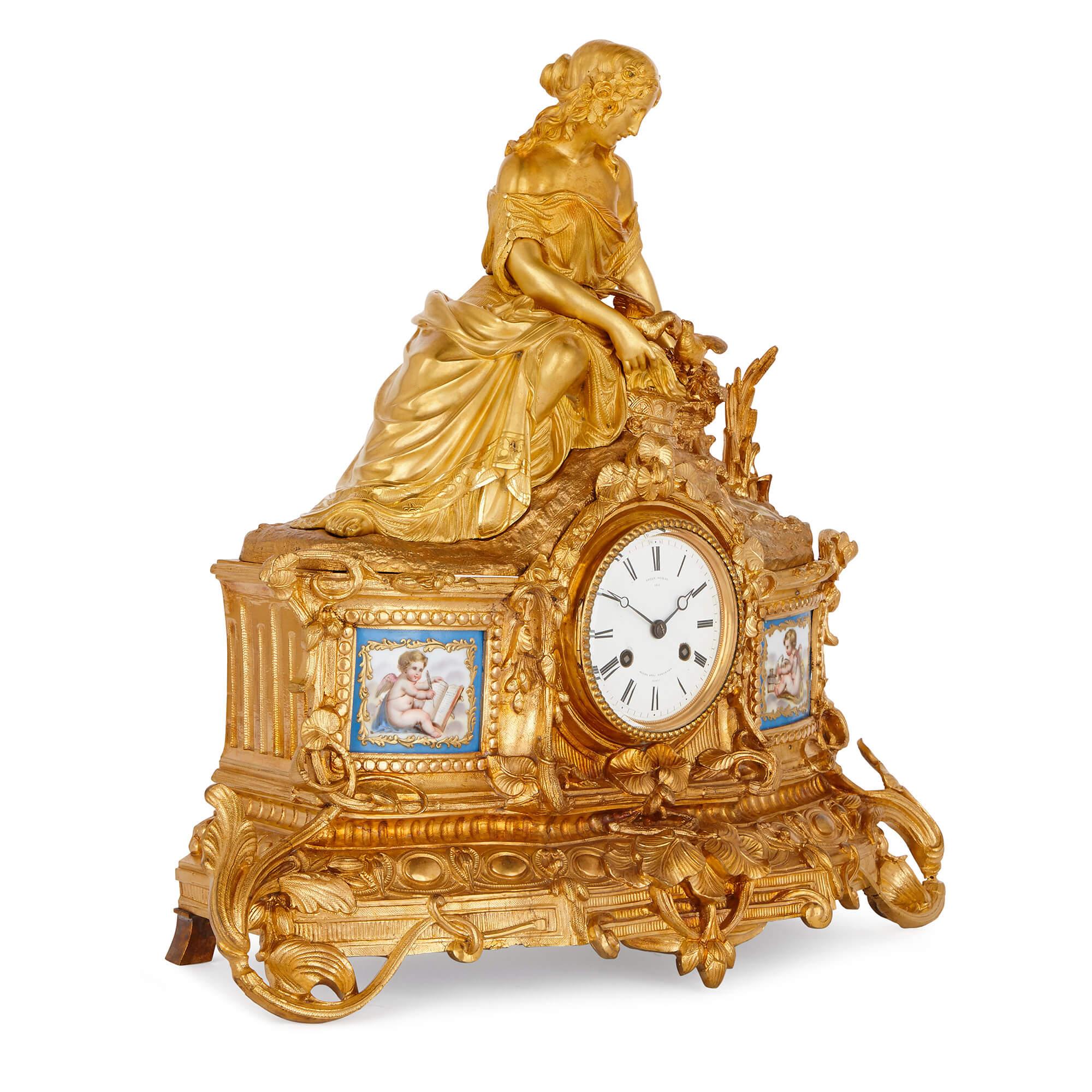 This sophisticated gilt bronze mantel clock is an elegant piece of mid-19th century design, beautifully cast and gilded and set with two delicate Sèvres style porcelain panels. The clock case's finest feature is the charmingly naturalistic scene at