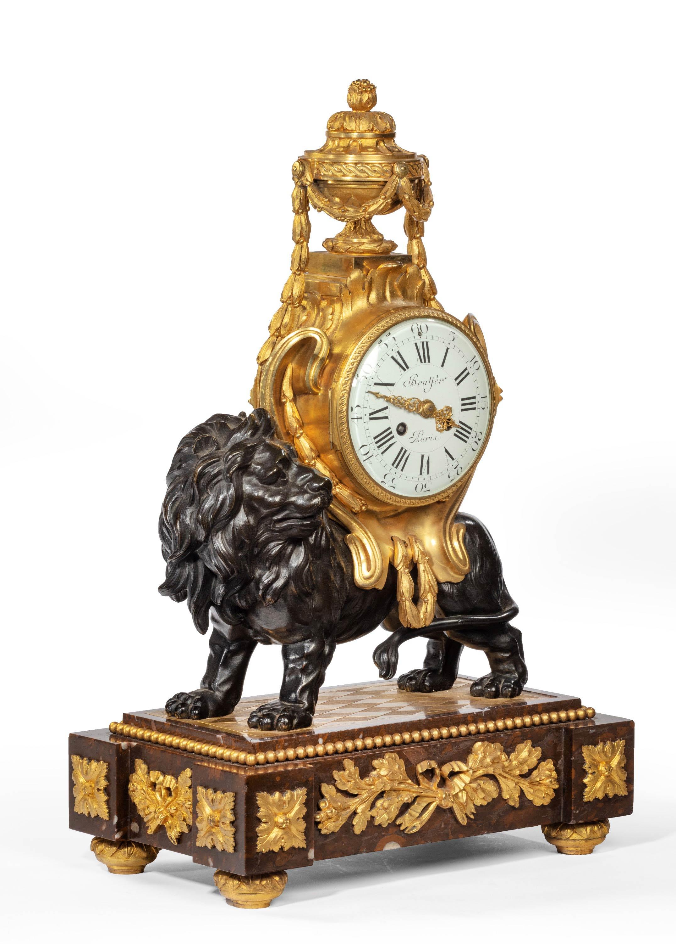 A very finely cast bronze and gilt bronze French mantel clock by Brulfer of Paris France with a marching lion. With a beautifully finished enamel dial signed Brulfer, Paris. Excellent overall condition. The whole of the metalwork unrestored.
The