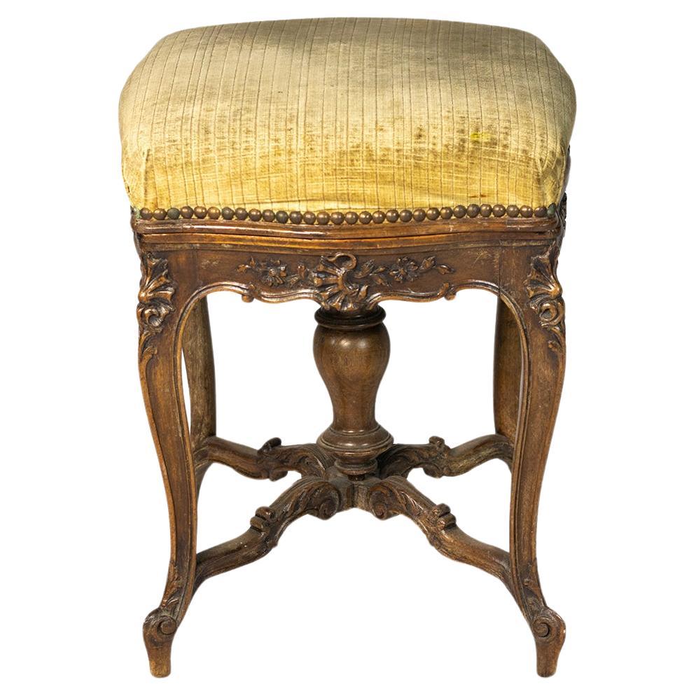 A unique 19th century Napoleon III Tripod Piano Stool richly carved in mahogany and mustard-colored velvet. 