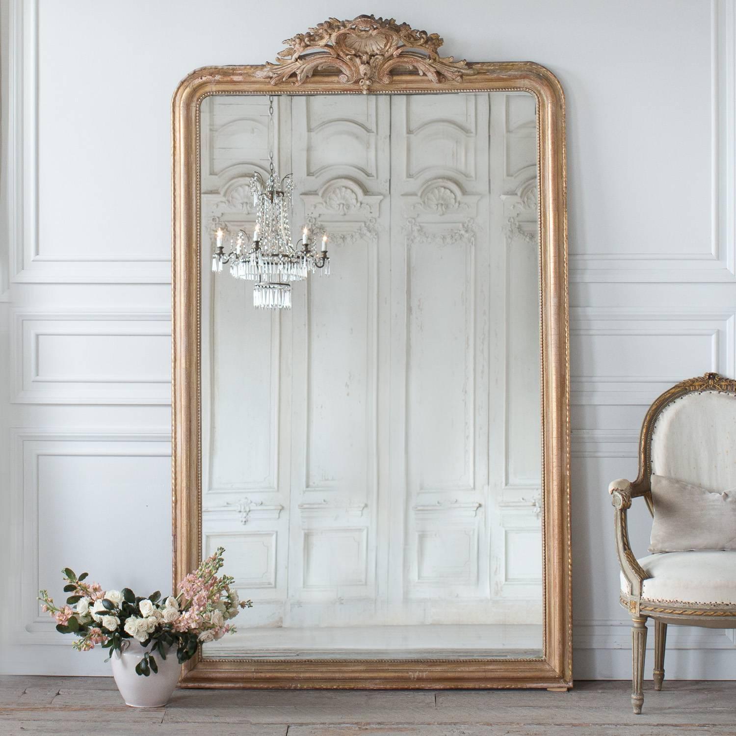 Charming, large standing Napoleon III style mirror with a scallop-themed crest. Original glass in incredible condition and boarded by a simple string of beads.