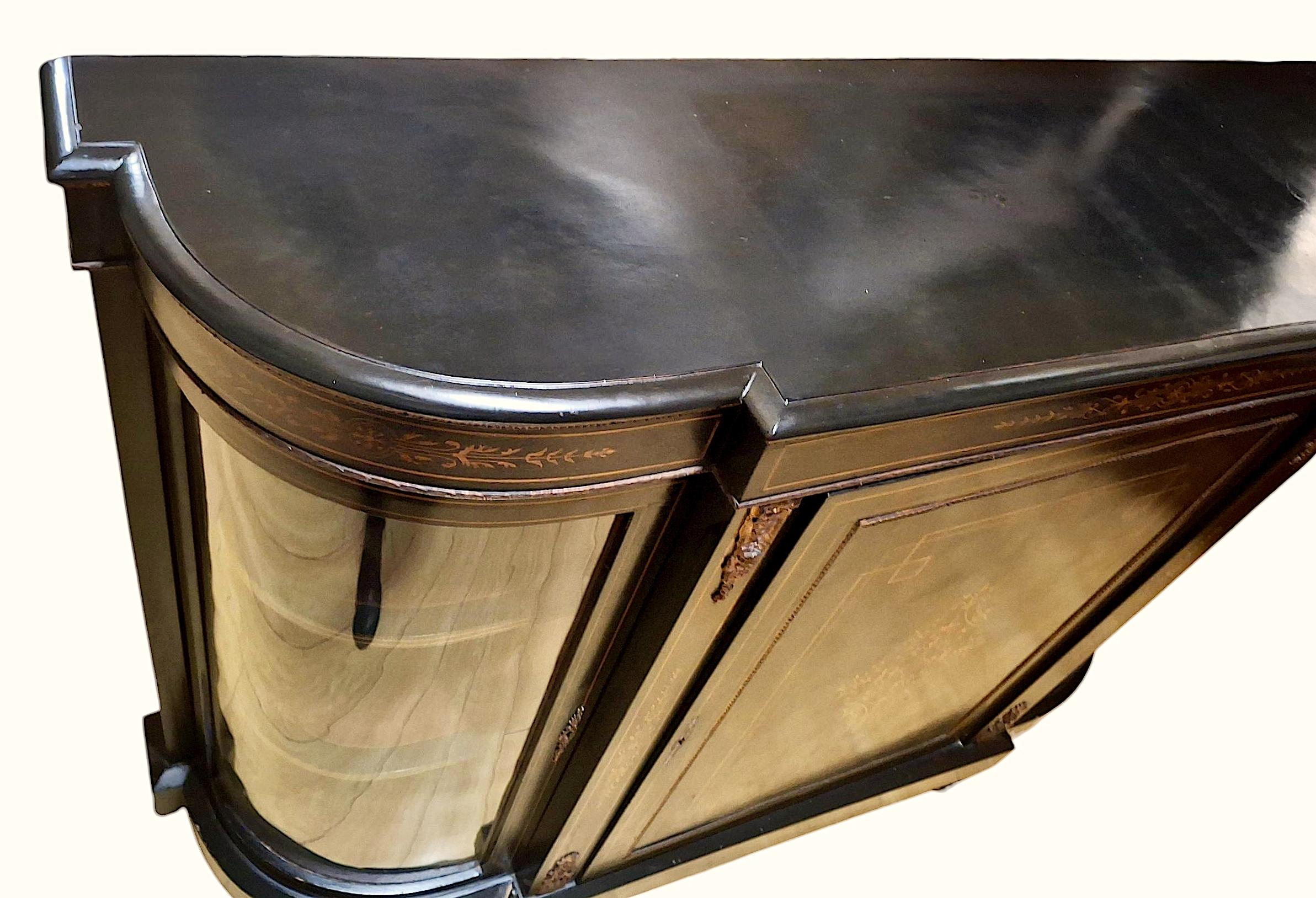 A tour de force of the Second Empire Style, circa 1852–1870, this credenza represents a time when French design was characterized by richness of inspiration and materials for newly wealthy industrialists.
The serpentine front features curved glass