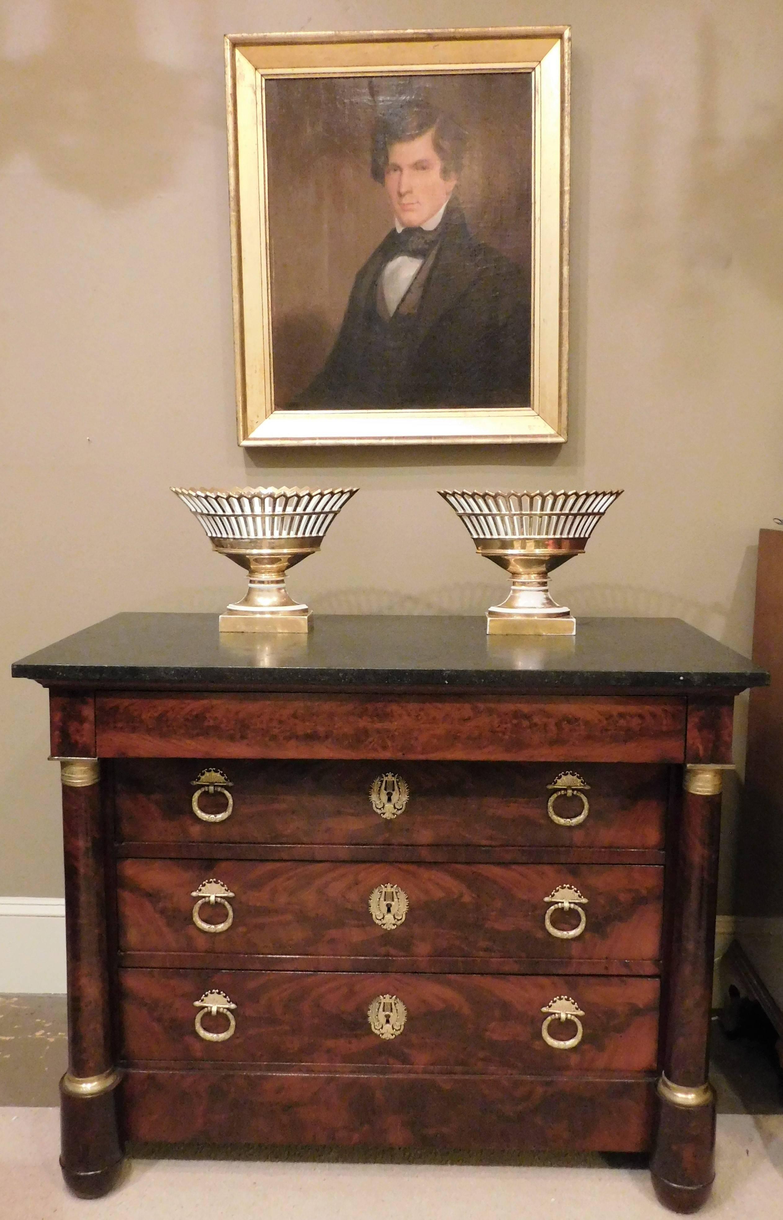 This commode (chest of drawers) has four drawers. The top drawer is opened by notches below and is divided into three sections; the second drawer is divided into two unequal-sized sections. It is made of French polished mahogany and mahogany