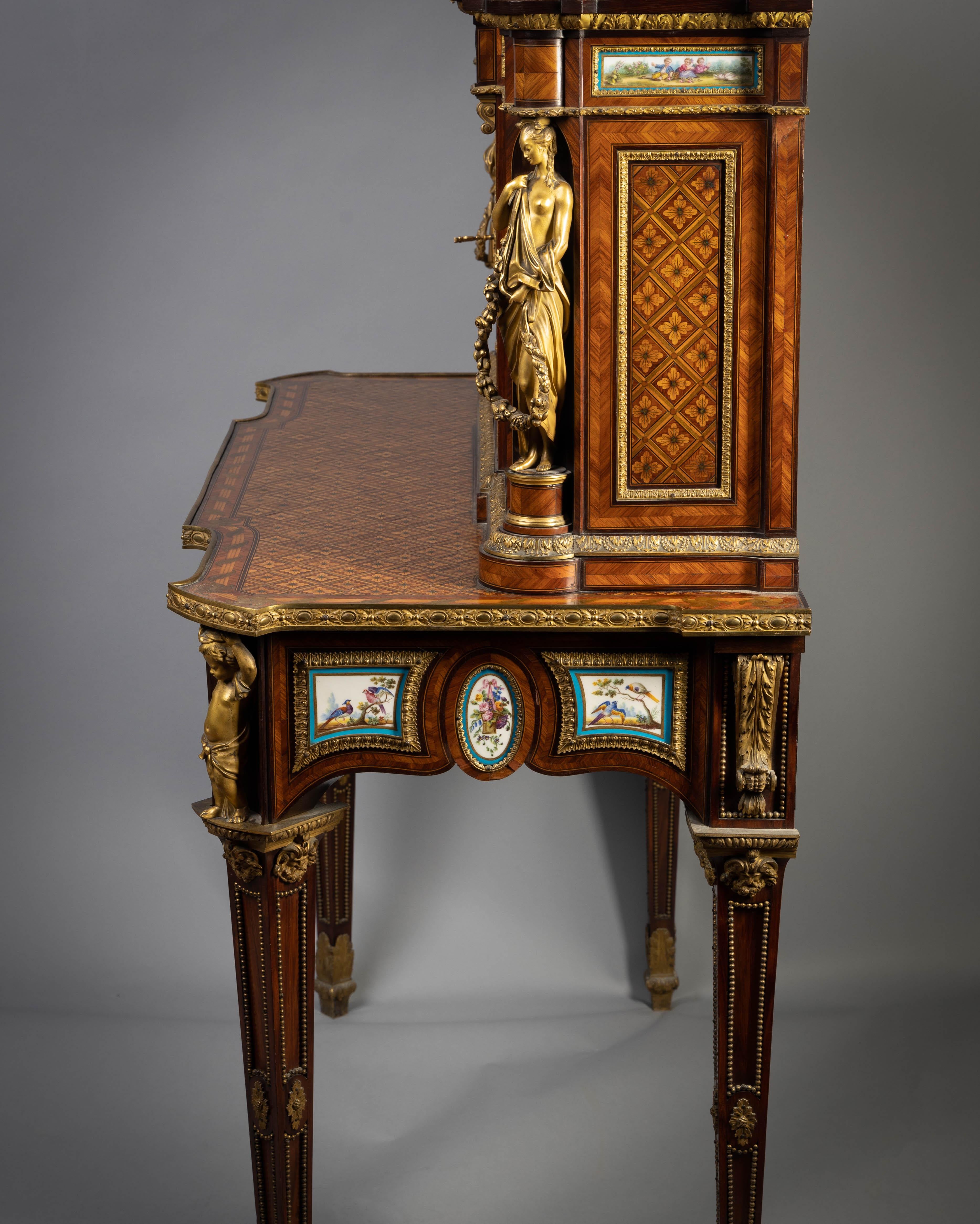 A fine Napoleon III Sevres style porcelain and ormolu-mounted tulipwood and parquetry Bureau De Dame, circa 1860

With stepped rectangular superstructure with three shaped rectangular ochre and red marble tops, above a central panel inset with