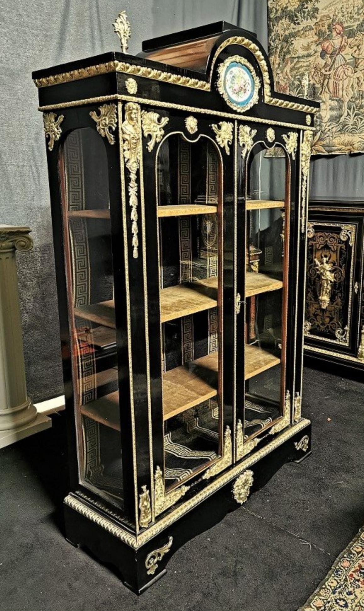 Stunning Napoleon III Boulle Vitrine bookcase 2 doors with a beautiful Sèvres Porcelain plate in a gorgeous and rare display case with 4 glass facades, with rich ornamentation of gilt bronzes, including a pair of high falls and the God Neptune's