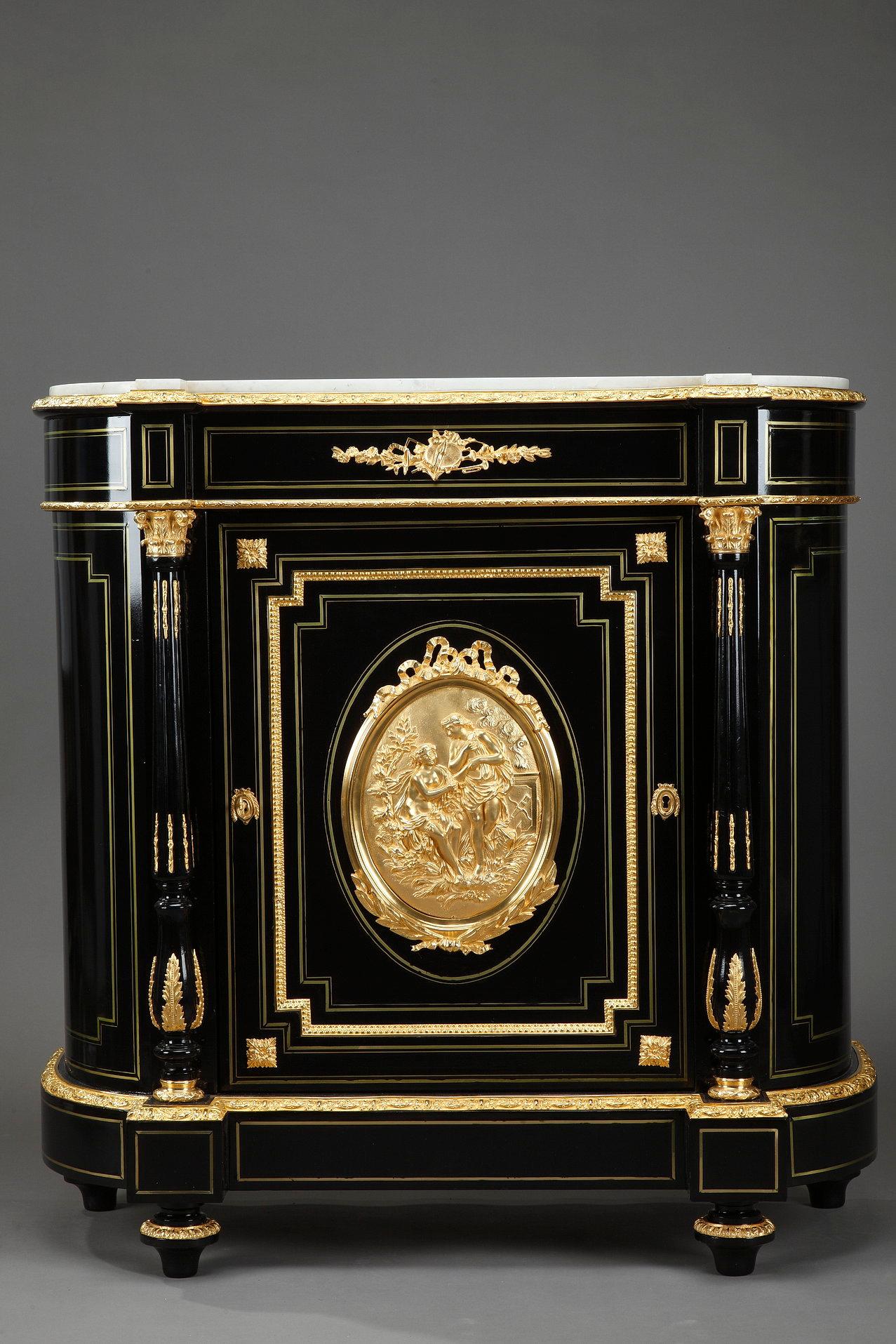 Blackened wood cabinet with fluted columns and arched sides topped by a white marble top. 

The cabinet is decorated with chiseled and gilded bronzes. Musical instruments ornate the belt. The medallion represents an allegory of Love with two