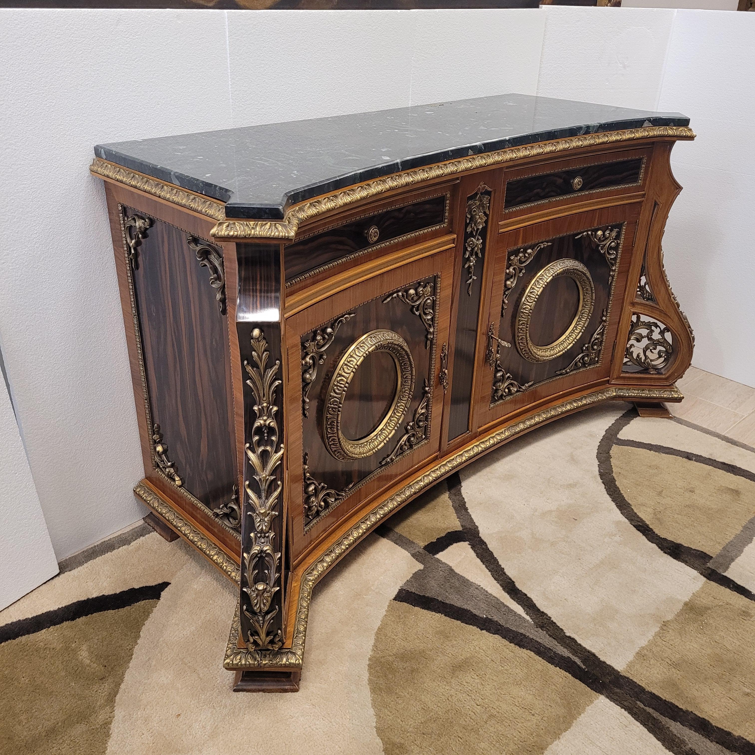 Spectacular and one of a kind French Napoleon III style sideboard in exotic and precious woods such as rosewood. Counter top in black marble and bronze throughout its presentation.
It comes from a private collection in France.
Enriched with bronze