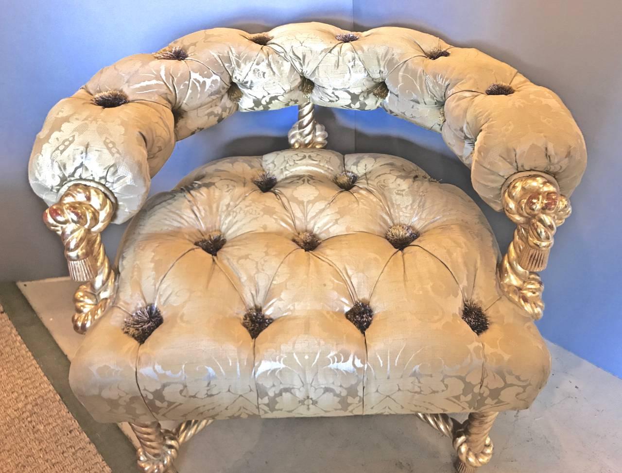 This Kelly Wearstler-designed chair is over-the-top: gilt rope carved frame silk damask upholstery and diamond tufting. As a further detail, the diamond tufting centers silk tassels in place of the usual buttons. The chair is definitely a unique