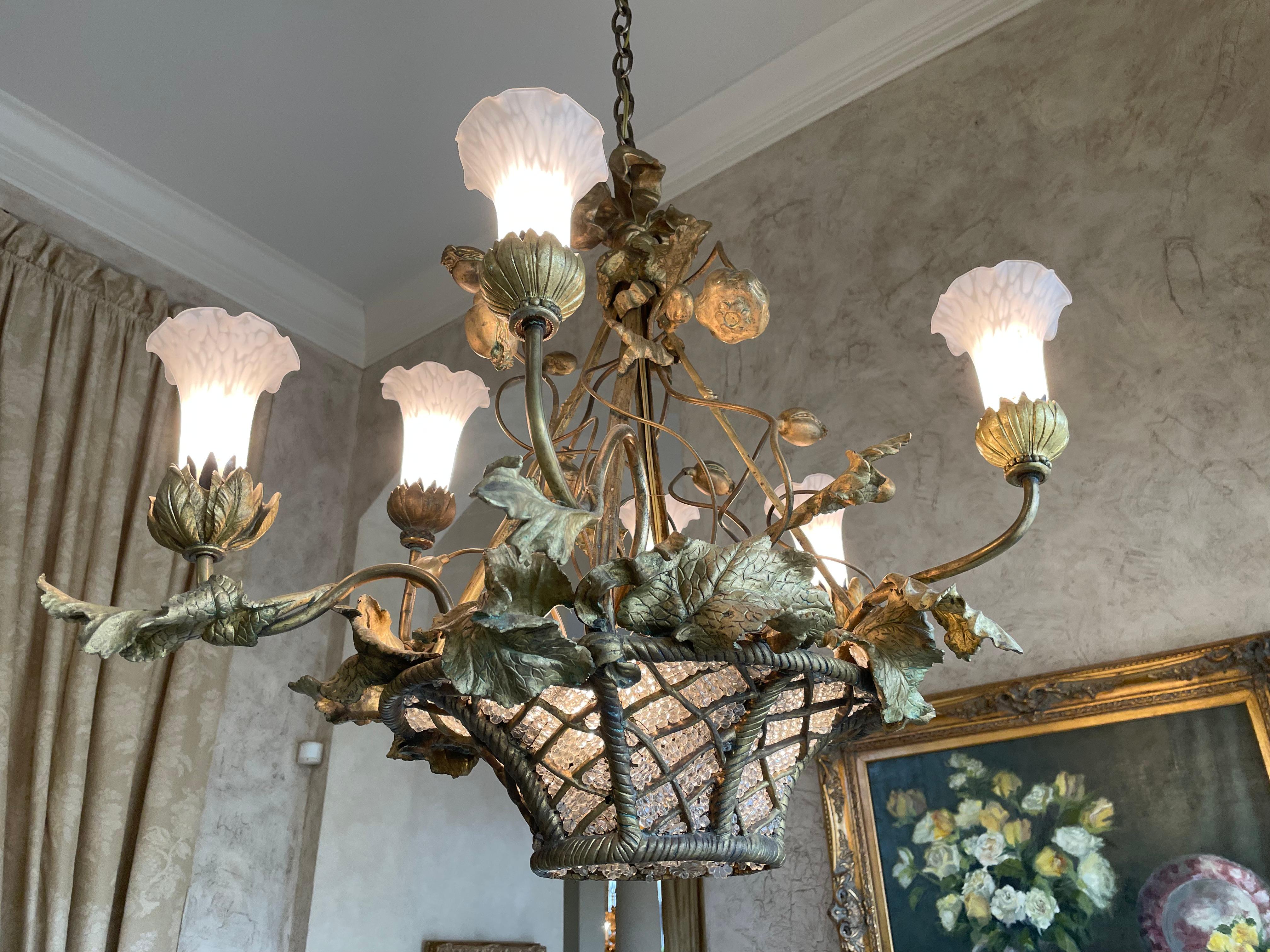 
Napoleon III Style Metal & Glass Bead Basket Six-Light Chandelier 
The metal basket-form frame set with glass beads, supporting upward set arms fitted with white floral-shaped glass shades. 
Height 28 in. (71.12 cm.), Width 30 in. (76.2 cm.), Depth