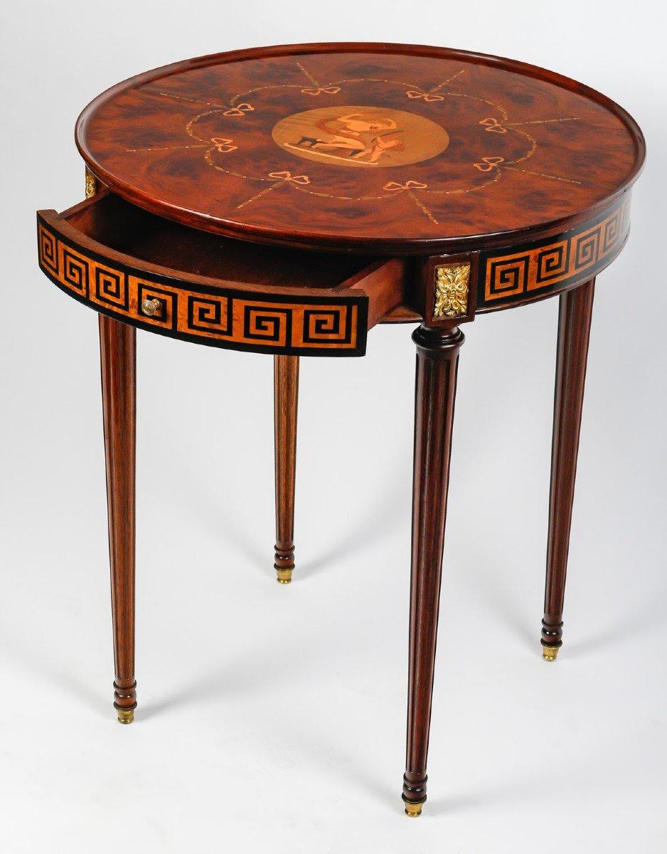 Napoleon III style pedestal table, 19th Century or early 20th Century in Wood Marquetry and Gilt Bronze.

A 19th century or early 20th century gilt bronze and wood marquetry pedestal table in the Napoleon III style.
h: 74cm, d: 62cm