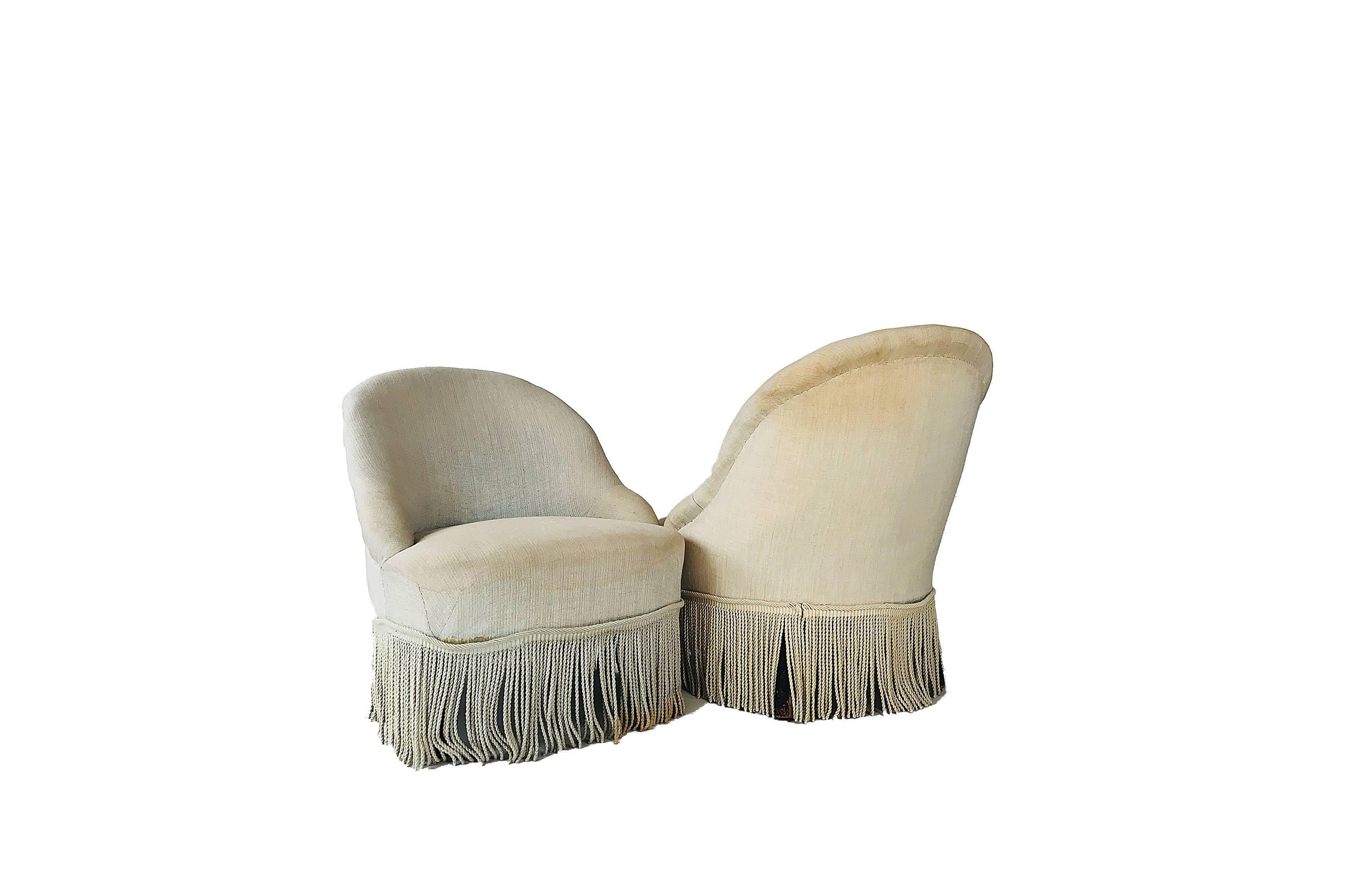 A pair of Napoleon III style slipper chairs with tassel decoration, circa 1880. Raised on turned walnut legs. Wonderful scale.