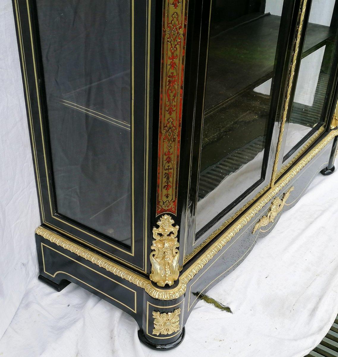 Napoleon III vitrine bookcase display cabinet in Boulle style marquetry opening with 2 doors, blackened wood and marquetry with brass threads and brass band on red tortoiseshell on the cornice and uprights. Beautiful gilded bronze ornaments.