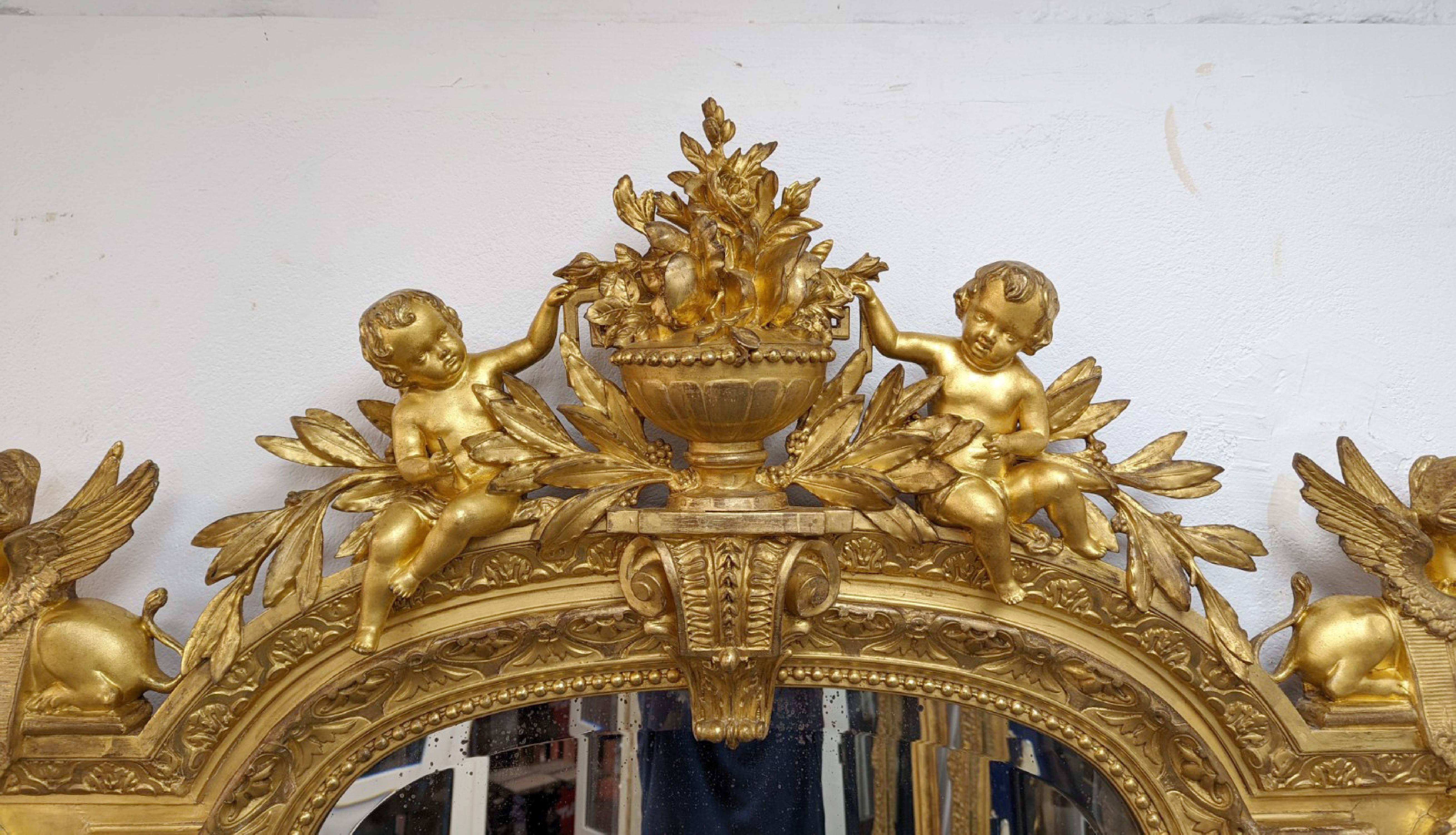 This exeptional trumeau was made gilt wood and stucco in the second half of the 19th century. It depicts a lavish high-relief decoration typical of the Second Empire style, giving prominence to sumptuousness and abundance of decoration often in