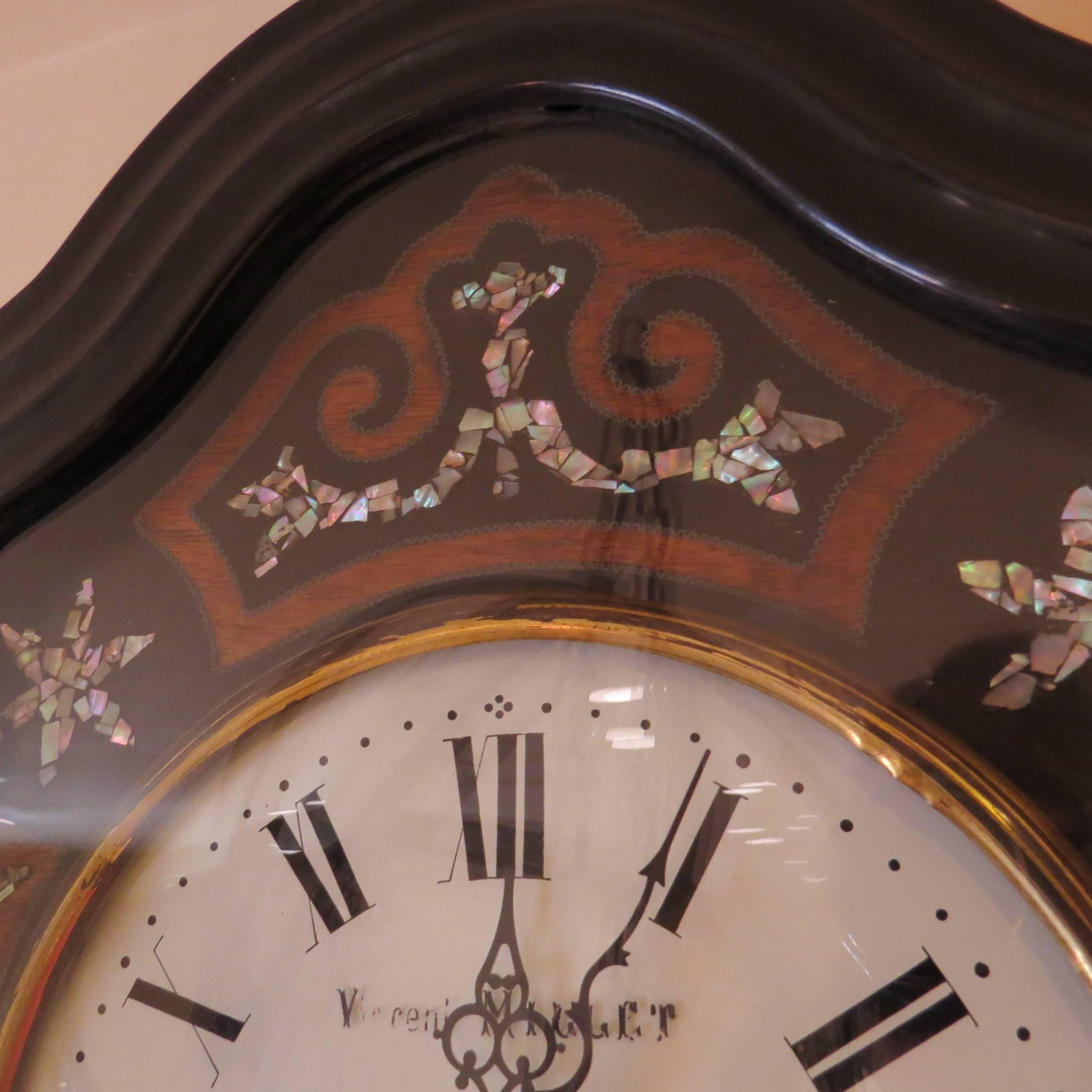 The pattern of inlay on the clock is made of shell. The signature on the enamelled face is 