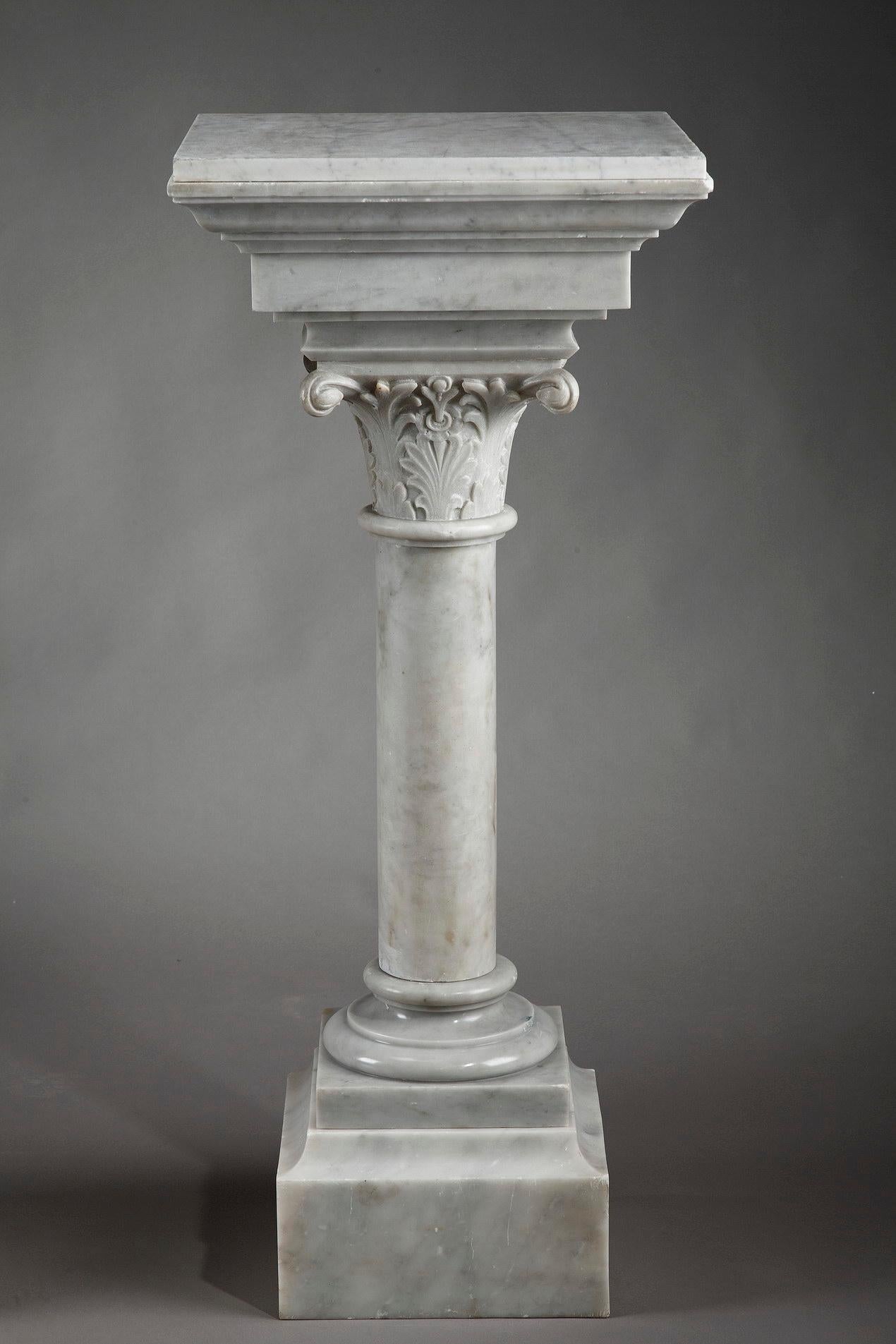 Pair of white marble column pedestal stands with large display plate. Crafted in the second half of the 19th century, these elegant French pedestals are complete with finely sculpted foliated capitals and large bands around the base, 

circa