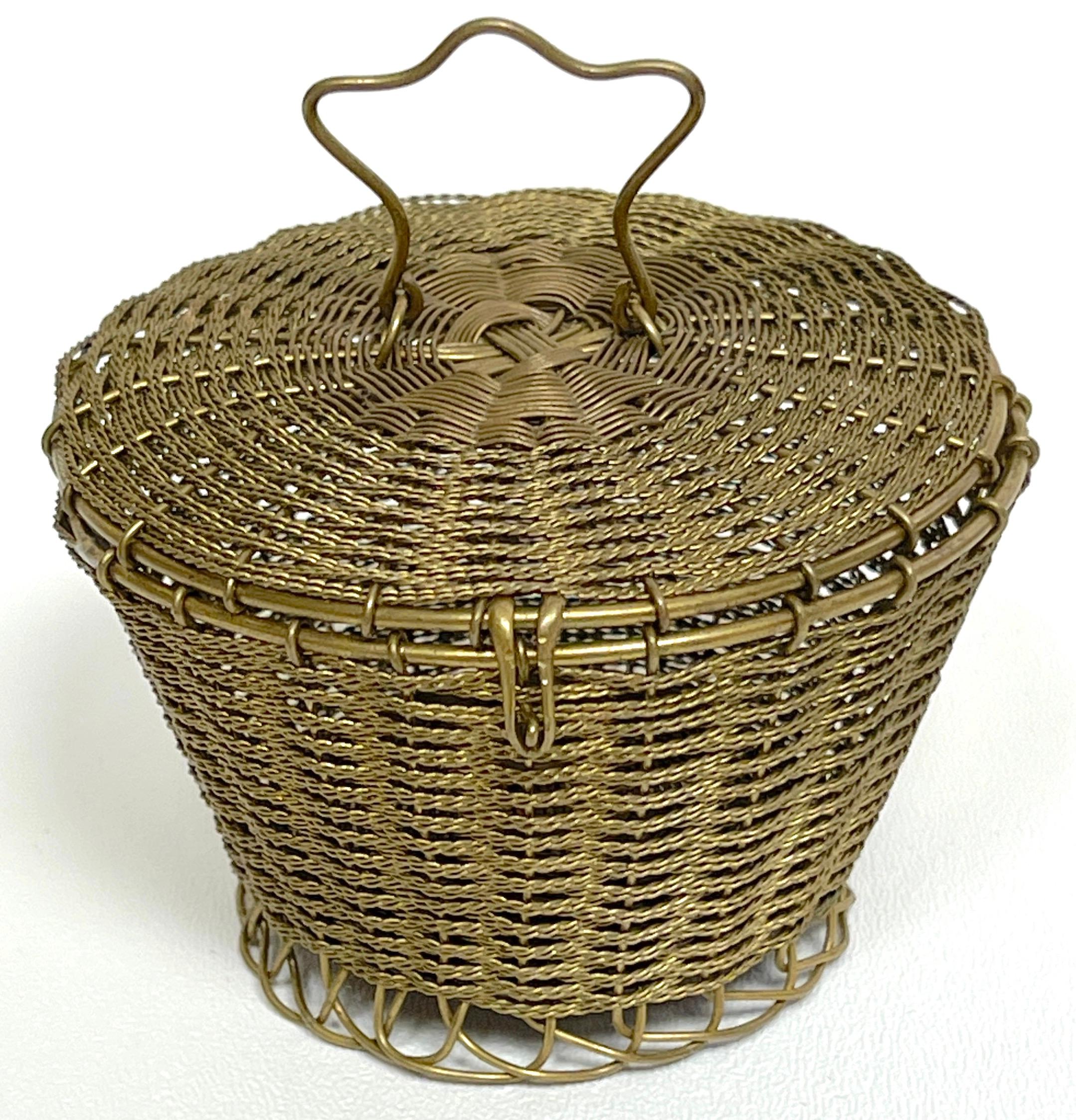 Napoleon III woven gilt bronze handled basket -weave table box 
France, circa 1875

A whimsical, yet intricately woven of a handled basket weave table box.

