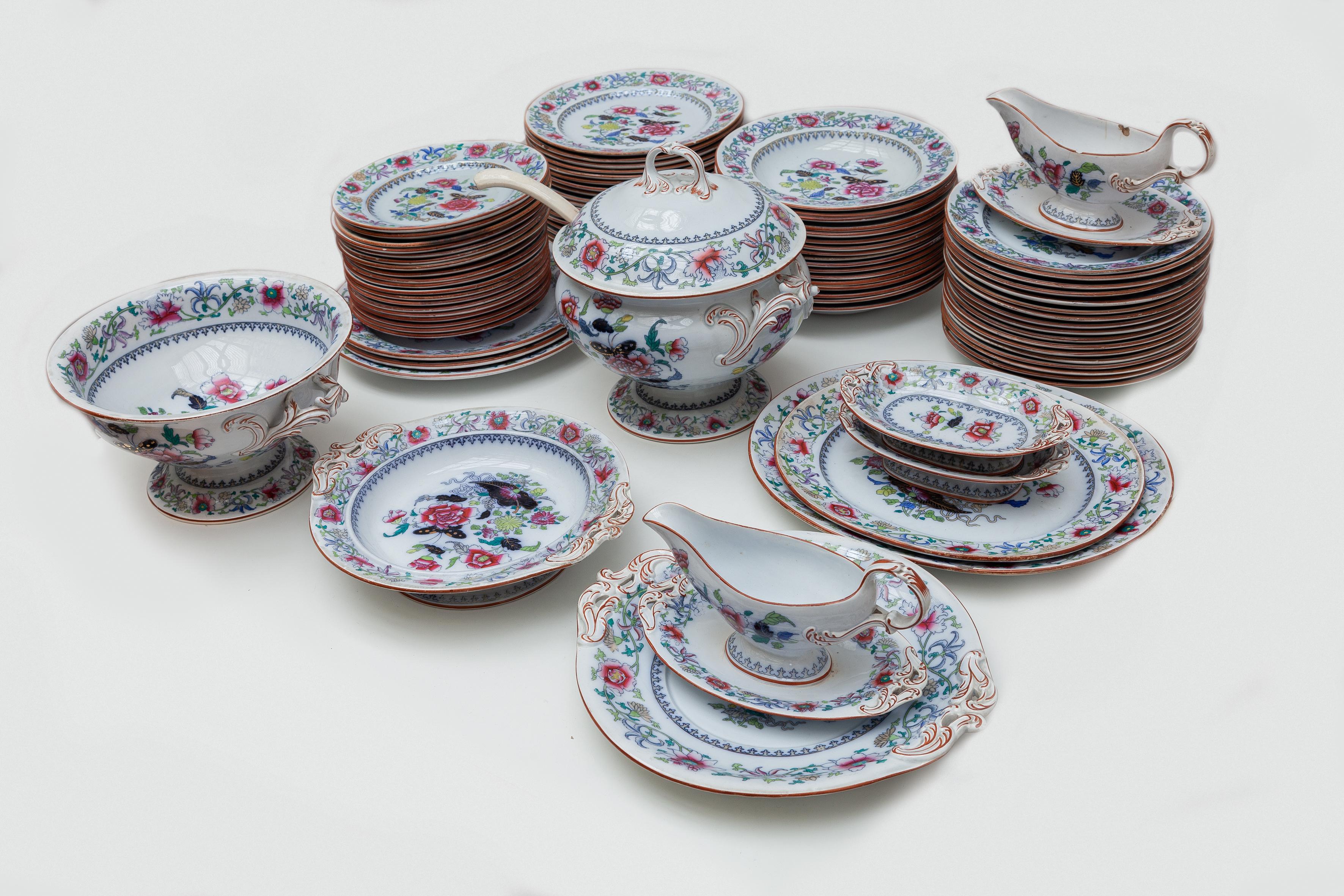 Dinner service set beautiful bright floral and butterfly motif in fine earthenware by Boch Frères. Polychrome Chinese Familie Rose decoration, covered with a glossy varnish. These dinner set has survived for more than 150 years without being