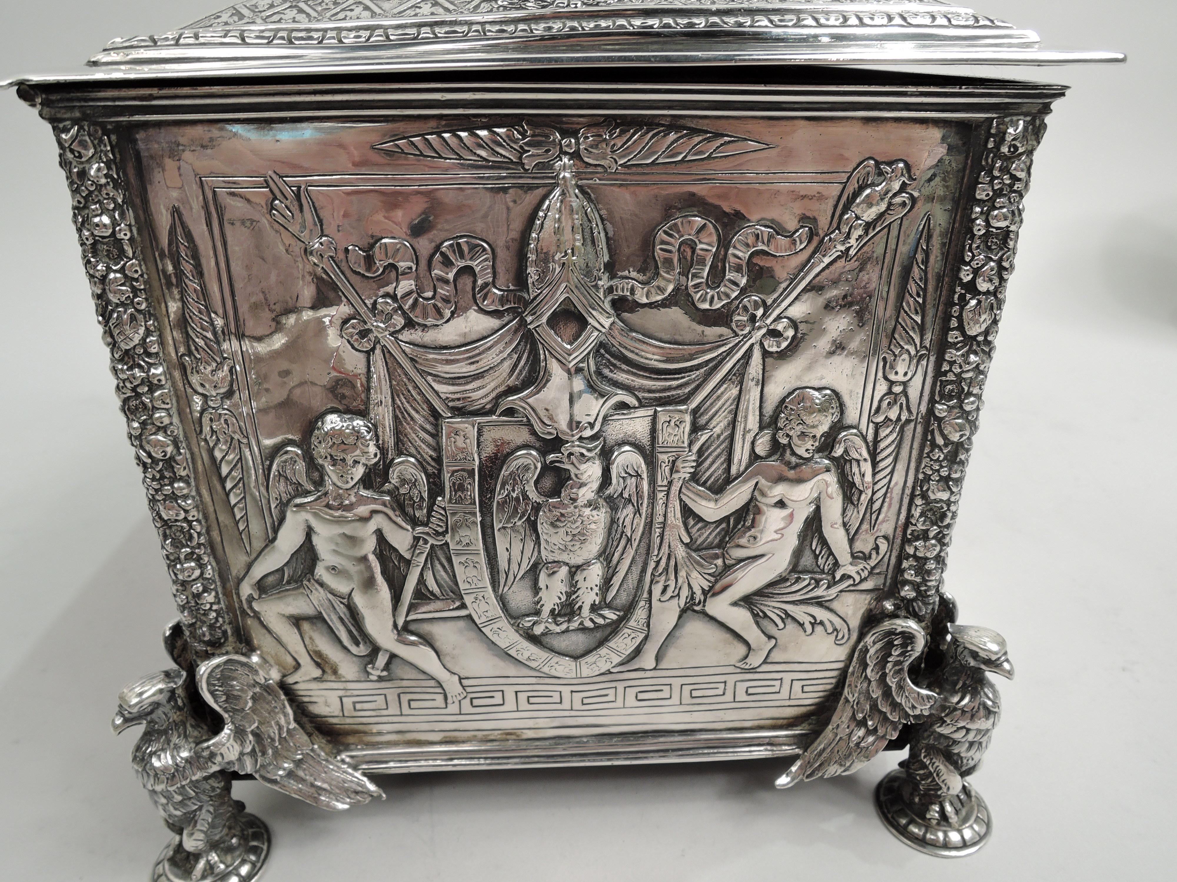Turn-of-the-century German 800 silver box with Napoleon theme. Rectangular with cast corner-mounted eagle supports. On box front is frieze of Napoleon being offered the key to a city; on back he addresses the supplicating vanquished. Both panels