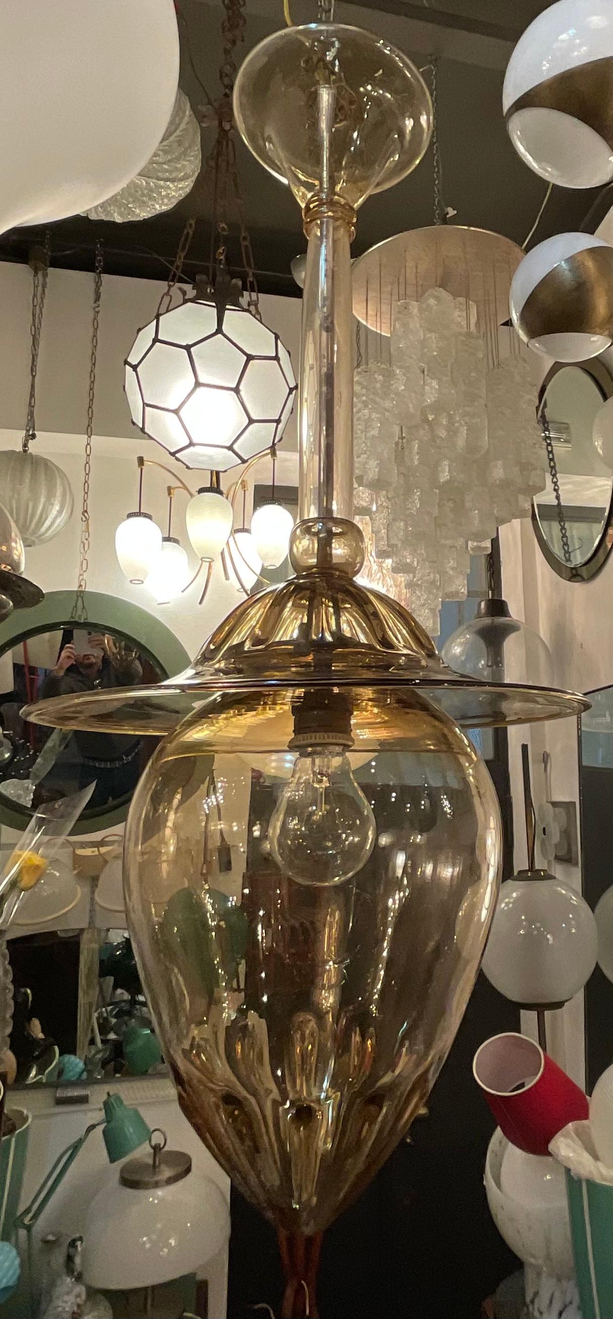 Disegnato da NAPOLEONE MARTINUZZI nella meta degli anni 20 del 900, questo bellissimo lampadario in vetro soffiato di murano appartiene alla linea dei lampadari modello DOGE.
Questo lampadario ad 1 luce ha un colore paglierino ed é in perfetto stato.