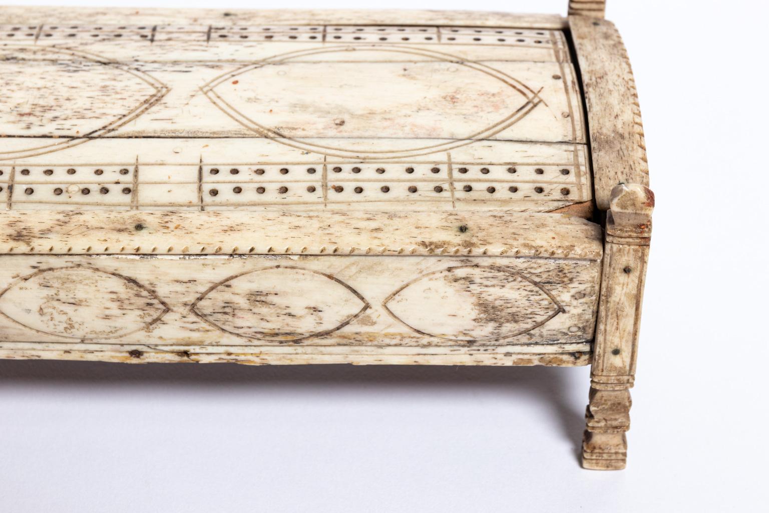 Cribbage box made by a Frenchman who was an English prisoner of war from stewing bones, circa 1800. With slide top revealing storage space. Please note of minor scratches.